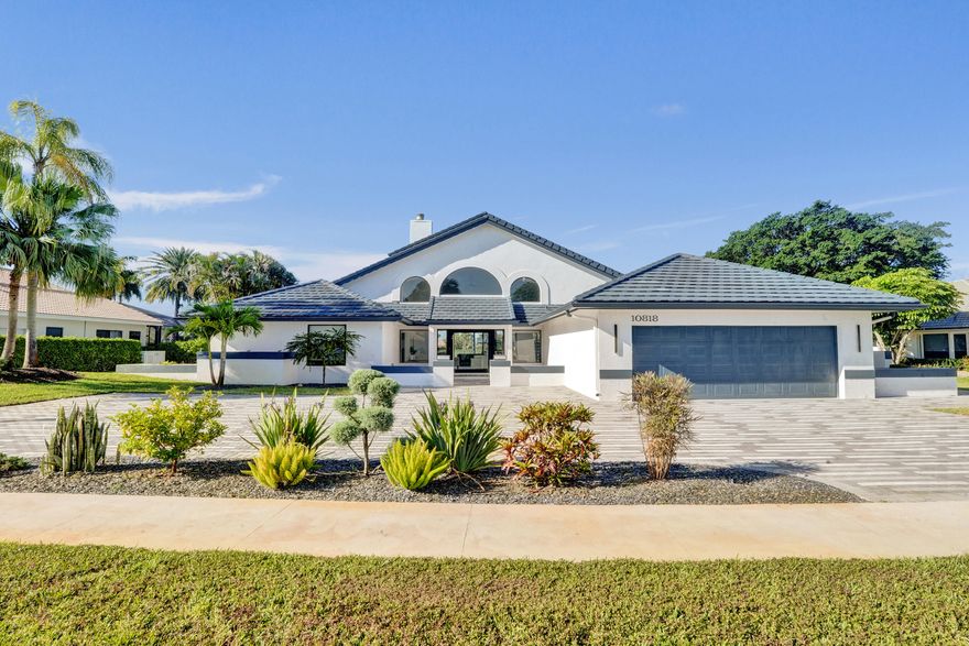 Experience refined South Florida living in this fully renovated 3-bedroom, 4-bathroom residence located in prestigious Boca Woods Country Club. Spanning approximately 3,400 square feet, this exceptional home features soaring 20-foot cathedral ceilings, creating a dramatic light-filled living space perfect for entertaining. A spacious den with private balcony overlooks breathtaking golf and lake views of the 10th tee on the Woods Course. High-end appliances, premium finishes, custom closets, impact-rated hurricane windows, Bose audio system, indoor bar, cabana bath, renovated pool, and outdoor kitchen complete this luxury retreat. Boca Woods offers a private gated country club lifestyle with two championship golf courses, tennis, pickleball, fitness center and elegant clubhouse dining.