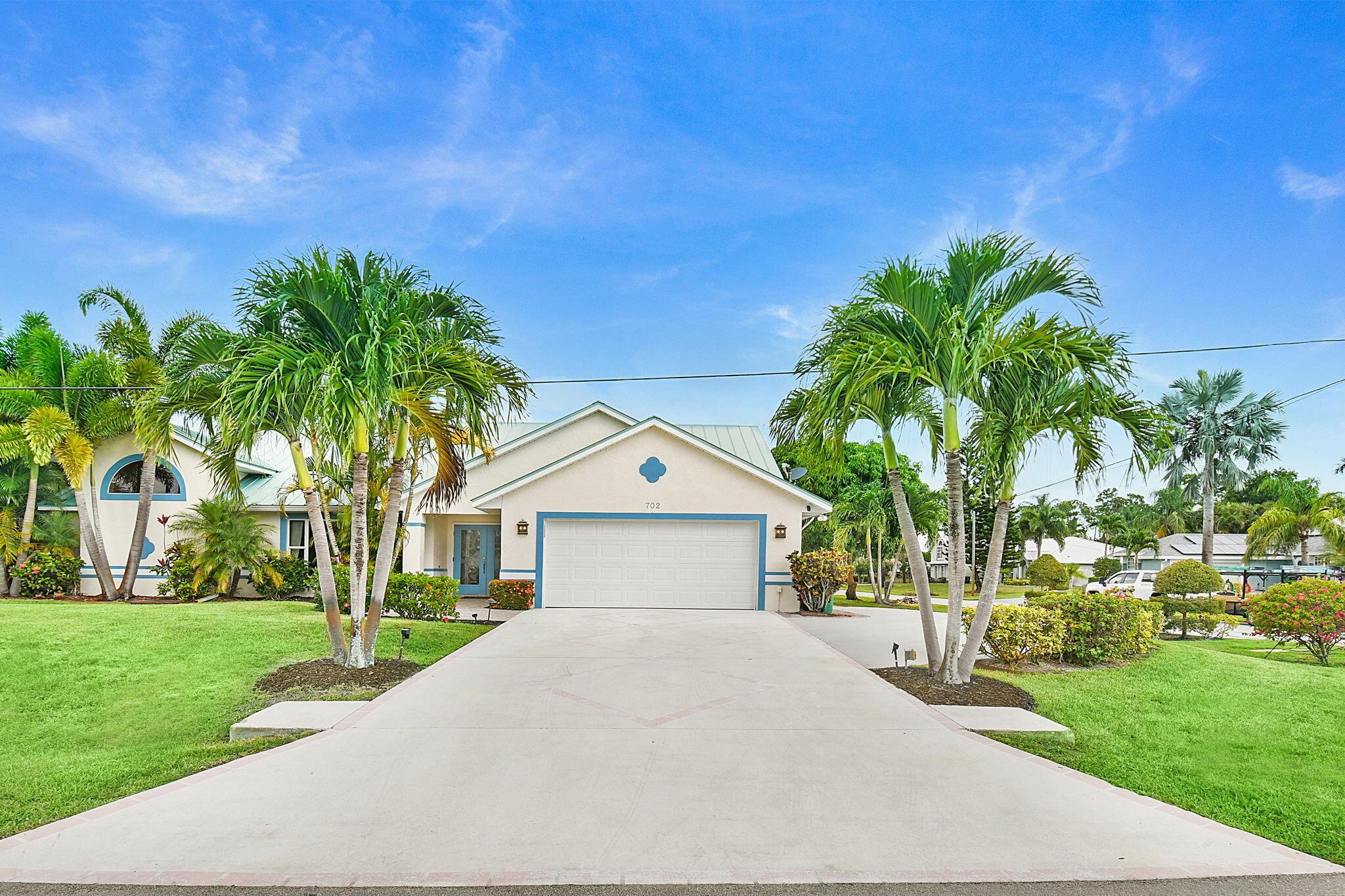 Waterfront Paradise with Ocean Access -- Ideal for Boaters & RV Enthusiasts!Welcome to your South Florida coastal retreat! Perfectly situated on a premium corner lot with direct ocean access and no fixed bridges, this stunning CBS home offers 4 spacious bedrooms, 2 updated baths, and a 2-car garage. Meticulously designed for both comfort and entertainment, the property boasts a screen-enclosed pool and expansive patio, seamlessly blending indoor and outdoor living. Boating enthusiasts will appreciate the private dock with lift, full electric and water hook-ups, while RV owners will find the rebar-reinforced driveway with dedicated A-Class RV parking, complete with electric service, a rare and invaluable feature. The circular drive provides ample guest parking for effortless entertaining.