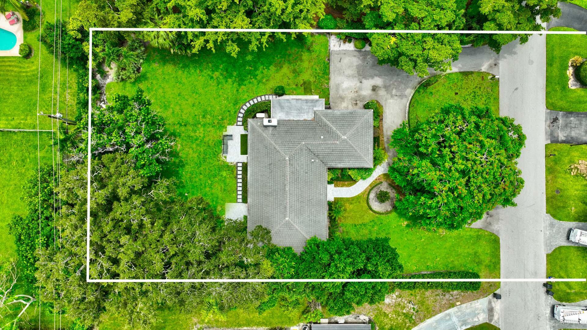 Exceptional opportunity to own a turnkey, fully furnished Delray Beach home on over one-half acre. Beautifully renovated, this residence offers 2 bedrooms plus office and a seamless blend of comfort and sophistication with open kitchen flowing into a sunlit family room lined with glass doors that invite natural light and views of the expansive property. The primary suite features a custom bathroom and 2 spacious walk-in closets, while the thoughtfully landscaped grounds enhance privacy and curb appeal. Additional highlights include a 2 car garage, circular driveway, newer roof (2020), impact windows and doors (2022), and a location just minutes from the beach, Atlantic Ave, and top-tier amenities. A move-in-ready residence that captures the essence of Luxury Living in Coastal Delray Beach
