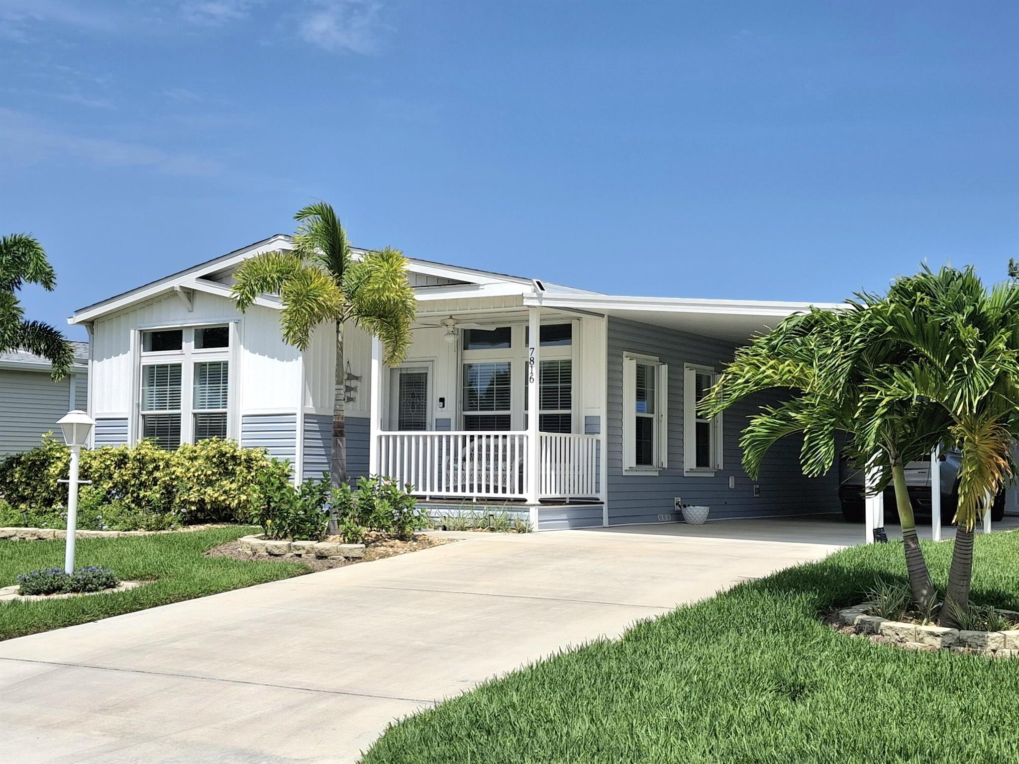 Fabulous 2022 home overlooking the golf course with 2 bedrooms, a den, AND a golf cart garage with a remote control door. Modern kitchen with a large island with seating, pendant lighting. Kitchen has wine cooler, and a pot filler over the stove, SS appliances and an exceptional amount of cabinets. The expansive 26x8 back lanai overlooks the golf course and has roll down roll down shades. Complete accordion shutters around the house. The master bath has dual sinks with LED mirrors, ceramic tile shower and the guest bath has ceramic tile shower with tub and LED mirror as well. This home has a 4 year warranty left so the new owner has peace of mind. The laundry room comes with a washer, dryer and a sink for your convenience. Features a front porch too! Furniture Negotiable.
