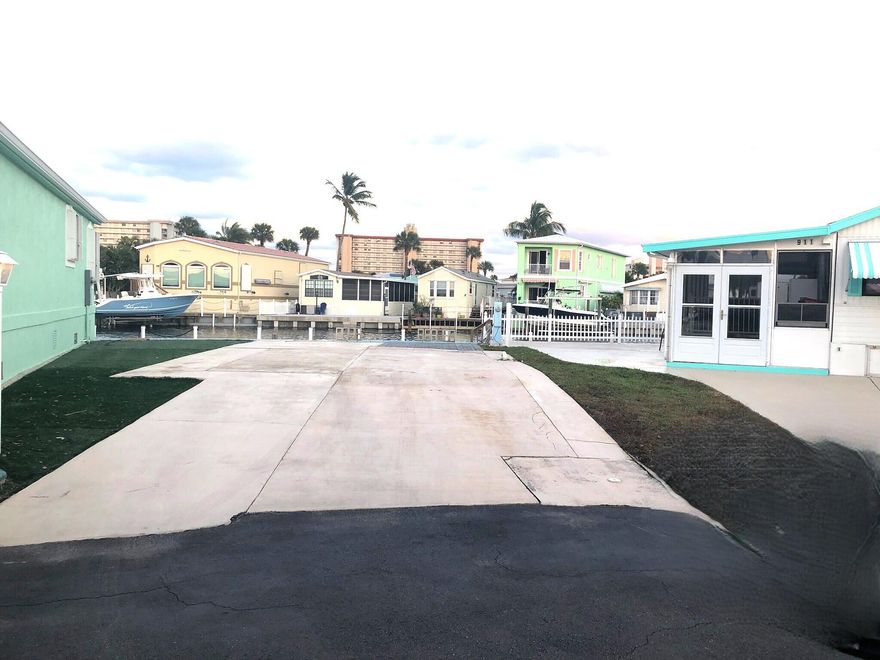 Direct Intracoastal water access lot on S. Hutchinson Island. Build your custom island beach home or bring your RV.  Rare opportunity to purchase waterfrontage of over 40'.  Dock up to a 34' boat & expansive views of the 80ft wide canal, dolphins & sunrises.  Paved lot extends to waters edge with a step down for easy accessibility to your boat. Venture 3 is a gated & pristine, all ages community w/ resort like amenities.  Fish off your own dock, enjoy walks to the private beach access on the Atlantic ocean, clubhouse, pool, billiards, pickleball, tennis, boat ramp, active social clubs & more. Full sewer & electric hookups for RV's up to 40'. No rental restrictions, low maintenance fees and allows up to 2 pets. Fun island living with dining, museums & shopping nearby.