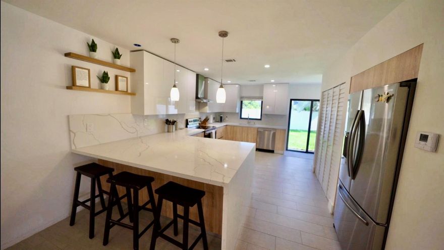 Beautifully updated 3-bedroom, 3-bath single-family home located just minutes from the beach in highly desirable Pompano Beach. This open-concept residence features a modern kitchen with quartz countertops, stainless-steel appliances, and custom cabinetry. Spacious living and dining areas flow seamlessly to a private backyard perfect for entertaining. Impact-rated windows and doors provide security and energy efficiency. Each bedroom offers generous closet space and its own dedicated or nearby bath, ideal for families or guests. Enjoy Florida living at its best with close proximity to beaches, restaurants, shops, and top-rated schools. Move-in ready and meticulously maintained!