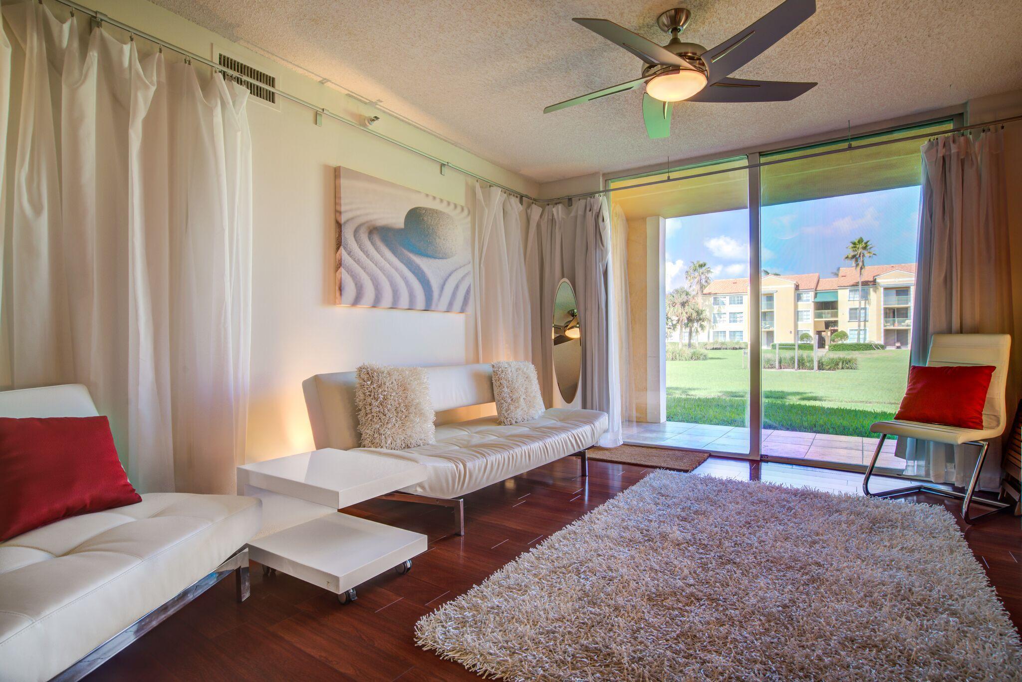 Beautifully updated first floor condo in the sought-after Yacht Club on the Intracoastal! Enjoy the serene views of the water, green area and Clubhouse right from your living room and private patio. Furniture is negotiable. Offered Fully furnished, partially furnished or unfurnished. Laminate Wood flooring throughout living areas and bedrooms. A/C installed in March 2022. Red Ikea kitchen cabinets with white quartz countertops. New washer (2024) and new over-the-range microwave. The Yacht club offers resort-style amenities including 2 swimming pools, tennis/pickleball courts, Marina, clubhouse, exercise room & more. Great as primary residence, vacation home or investment property. Association has 725 credit score & approval requirement for tenants.Available for Annual or Seasonal Rental