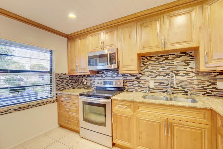 Stunning fully renovated 2BR/2BA 2nd floor condo with gorgeous golf views! All impact windows!  Kitchen features light wood cabinets,,granite and stainless steel appliances.  Spacious master bedroom with 3 closets, Master bath with Jacuzzi tub and separate vanity / dressing area.  good sized guest room / office, and large living / dining room. fully open to kitchen. Guest bath with walk-in shower, frameless glass door and washer and dryer. Ceiling fans in every room. Large screened and covered patio overlooking golf course which is being totally renovated. EXTRA...Walk to the community pool and enjoy the Boca lifestyle. 55 + community. Will rent furnished or unfurnished.