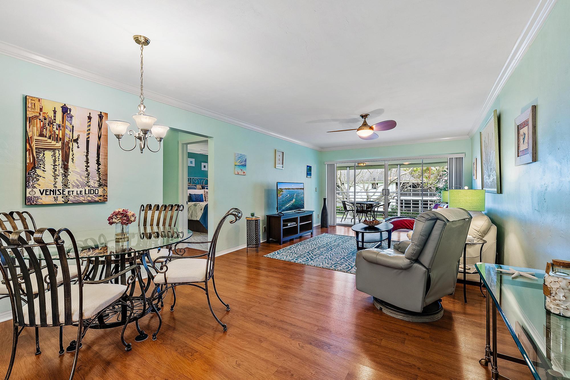 Looking for the perfect place to call home? This beautiful 2nd floor, 2-bedroom, 2-bathroom, furnished condo with nearly 900 square feet of living space is available for rent, available for move-in April 1st of 2025! Available until October 31st, this condo is the perfect spot for you. Featuring full hurricane protection and an expansive screened-in patio, this condo allows you to enjoy the peaceful South Florida lifestyle with ease. Step inside to discover a light and bright living space with plenty of natural light and beautiful wood-like laminate floors flowing throughout the main areas. To the left, you'll find a dining area and an updated eat-in galley kitchen with stunning white shaker cabinets and ample storage, including convenient