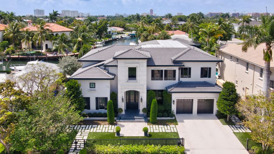 Located on one of the most sought-after streets & communities in East Boca Raton, this spectacularly custom crafted contemporary waterfront estate exudes quality and refinement. This prime lot situated on 85 feet of deep water with a brand new raised dock and seawall, is the perfect retreat for the avid boater with no fixed bridges and only minutes away from the ocean. A complete rebuild transformed this two story estate into a stunner, boasting exceptional indoor-outdoor living, with no attribute left untouched. Step into the grand foyer featuring soaring ceilings and opening to an exceptional floor plan. Sleek craftsmanship, unparalleled quality, and a unique mix of bespoke and warm finishes throughout the entire home makes this estate fit for the most discerning occupant. See 'More'..