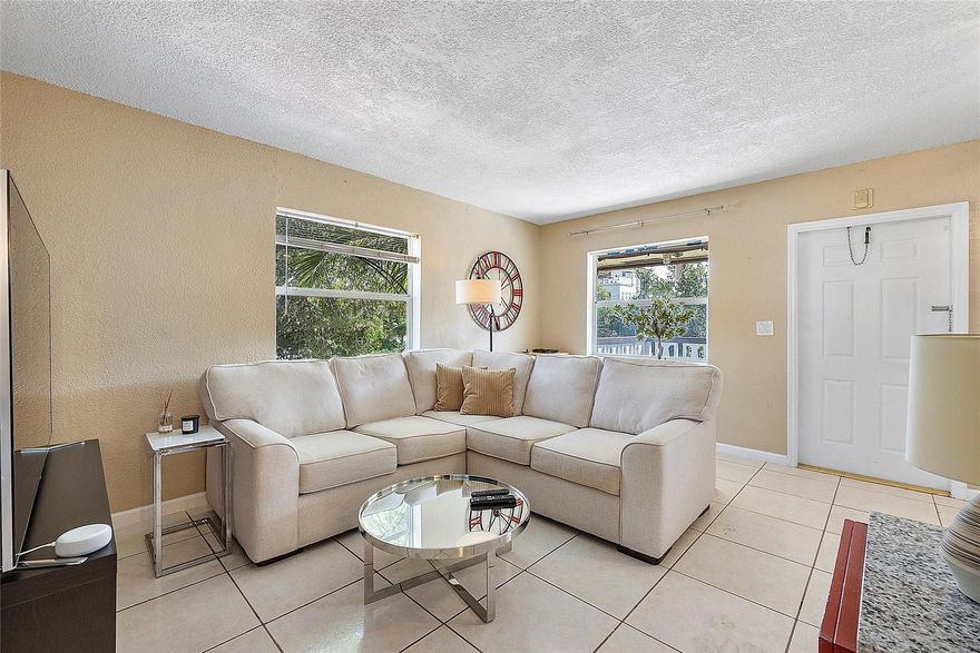 This sunny and inviting corner unit features extra windows that flood the space with natural light. Recently updated, it includes sleek tile flooring throughout and a modern kitchen with stainless steel appliances including a  1 year old AC, and a 3 year old Water Heater. Located on the second floor, this condo offers privacy and charm, and it's currently leased at $1700—making it a great option for investors seeking immediate rental income. Low HOA fees add to the property's value, making it a smart investment in a thriving area. NEW ROOF AND EXTERIOR PAINT IN 2024. The unbeatable location, just a short distance to Wilton Manors’ vibrant nightlife, eclectic dining, scenic parks, and top-rated schools.