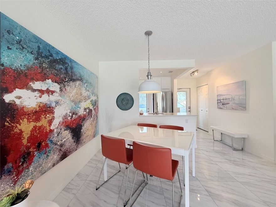 BEAUTIFULLY RENOVATED 2BR/2BA first-floor condo with STUNNING LAKE VIEW from the Florida room. Features an OPEN KITCHEN w/ sleek textured white cabinets, stainless steel appliances, and recessed lighting. ELEGANT DECOR & FURNITURES. MARBLE-STYLE tile throughout in white & light-grey tones. SPACIOUS WALK-IN closet w/custom cabinetry. MOVE-IN READY and IMPECCABLY MAINTAINED _ TRULY A MUST-SEE!**AC 2020 - Tankless** Very well maintained building w/reserve funds.Community boasts heated pool, billard, gym, BBQ area, clubhouse and more activities. Minutes away from shops, resaurants, supermarkets, highways and beautiful beaches.