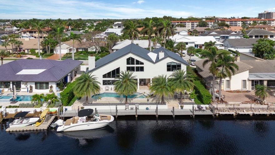 Coastal Contemporary gem in The Prestigious Lighthouse Point Community, offering 85ft of deep water access, no fixed bridges. Sail effortlessly to the Intracoastal/ocean from your backyard. Soaring ceilings, abundant natural light, open floor plan. Chef's kitchen by Allied Kitchens with Sub Zero, Wolf appliances is a Culinary Masterpiece. Impact Windows & Doors, White Oak Wood floors on second level & staircase, marble-paved backyard with Salt Water Heated Pool/Spa, Outdoor Shower & new Summer Kitchen w/ Grill, Bar Seating & Ice Chest. Meticulously landscaped surroundings. Dock & seawall updated in 2019. Master Suite with dual custom closets, oversized Modern bathroom & loft. 3 beds downstairs + 2.5 baths complete this waterfront haven of luxury living.