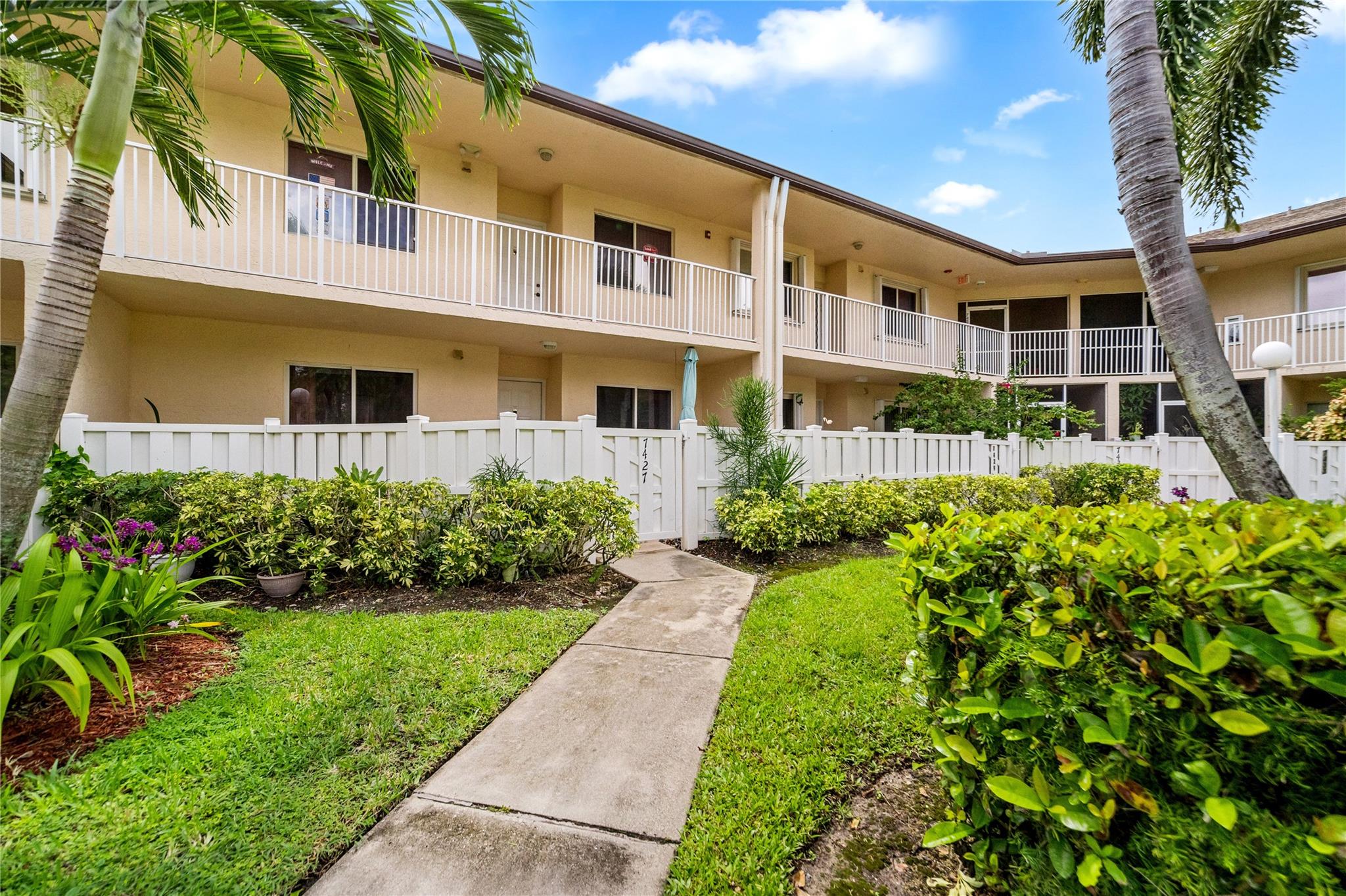 Welcome to Devon at Kings Point, Your Next Chapter Starts Here! This 2-bed, 2-bath condo in the vibrant 55+ community of Kings Point features a charming front garden entry with a bench to enjoy peaceful evenings. Inside, enjoy a bright layout with newer A/C, water heater, and updated flooring in the primary bedroom. Sliding doors in the kitchen lead to a private front patio, perfect for morning coffee or casual entertaining. The spacious laundry closet offers great storage and the back patio with acrylic windows lets you enjoy the space year round. Assigned parking right in front of Building J. Low-maintenance living in a lively, well-kept community!
