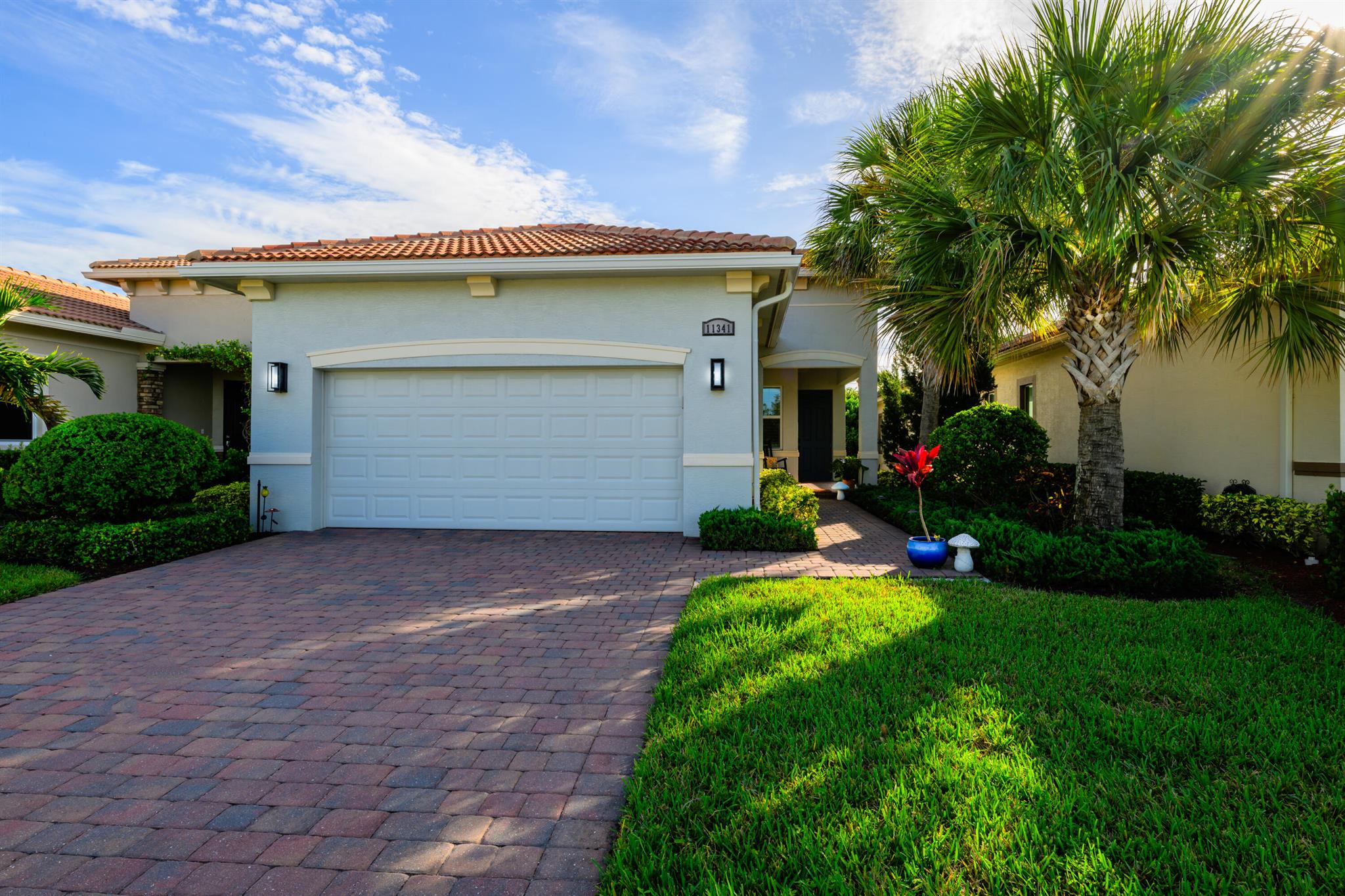 Welcome to 11341 SW Visconti Way, a stunning Arezzo model villa in the prestigious PGA Verano community of Port Saint Lucie. This meticulously maintained 2-bedroom, 2-bathroom home, plus a versatile den, offers 1,515 square feet of elegant living space, built in 2020 with modern finishes and thoughtful design throughout.Step inside to an open and airy floor plan flooded with natural light, featuring 10-foot coffered ceilings, crown molding, custom closets, plantation shutters and hurricane impact-resistant windows for peace of mind. The gourmet kitchen is a chef's dream, boasting white shaker-style cabinets, gleaming quartz countertops, a stylish tile backsplash, pendant lighting, bespoke appliances, and a custom walk in pantry.