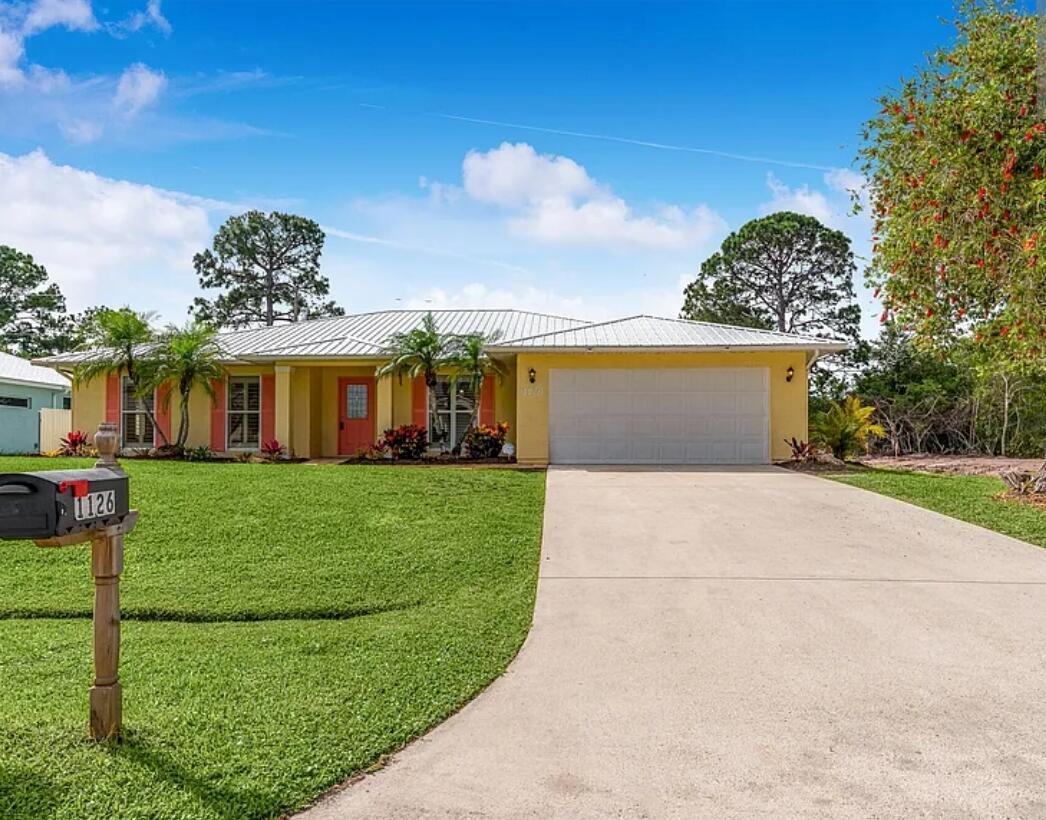 2022: A BRAND NEW METAL ROOF! This spacious, well-kept three-bedroom (potential fourth bedroom), two-bathroom, two-car garage home is convenient to everything PSL and Fort Pierce have to offer and is situated in a beautiful, family-friendly neighborhood. New landscaping, a formal dining area and living area on the entry level, a screened-in porch that overlooks the large backyard with space for a pool, stainless steel appliances, plantation shutters, a roman tub and shower in the master bathroom, plenty of closet space, sliding glass doors that open to the patio and backyard, and much more are among the features! It's close to US-1 and on a quiet street. Schools are within walking distance, restaurants and shops are five minutes away by car, and the ocean is fifteen minutes away.