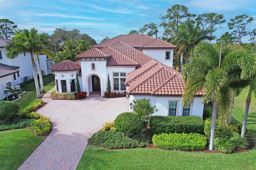 RIVERFRONT 'CASTELLINA' BY ARTHUR RUTERNBURG HOMES.  Nestled on a spacious, private riverfront lot, this magnificent 4,213 sq. ft. castle-inspired residence, built as a model home, professionally decorated & furnished offers a luxurious & enchanting living experience.  The exterior boasts grandeur with its intricate architectural details reminiscent of a classic castle. The property is surrounded by manicured, landscaped gardens in the front & undisturbed Florida nature in the rear down to the water & across the river to protected, preserve land.  Upon entering the grand foyer, you are greeted by soaring ceilings setting the tone for the opulence within.  The interior features four generously sized bedrooms each with its own en-suite bathroom adorned with high-end finishes & fixtures