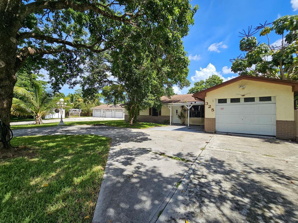 Photo of 325 NW Rebecca Avenue, Port Saint Lucie, FL 34983 (MLS # R11116327)