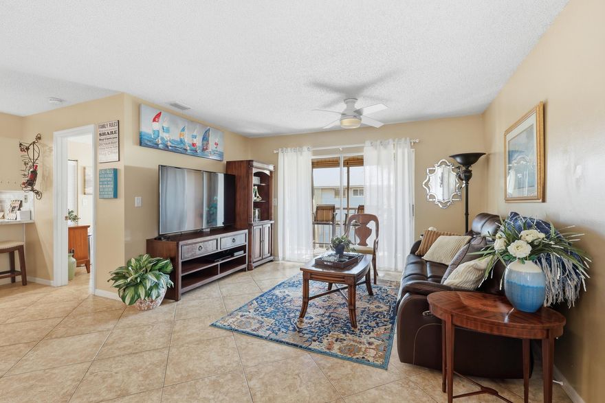Welcome to this beautifully maintained 3-bedroom, 2-bath corner condo in The Fountains of St. Lucie! Located on the second floor, this light and bright unit offers 1,116 living sq ft with an open-concept layout and vaulted ceilings that create a spacious feel throughout. The updated kitchen features modern cabinetry, stainless steel appliances, and a breakfast bar that flows seamlessly into the oversized 21x21 living and dining area -- perfect for entertaining. Ceramic tile flooring runs throughout the main living spaces for easy maintenance. Xfinity cable and Internet included in condo fees.  Additional features include inside laundry, detached covered carport, metal roof, and low monthly HOA fees that include cable, exterior maintenance, roof, insurance, lawn care, pool service, clubhouse, spa, and more. Conveniently located east of US-1 near shopping, dining, beaches, and medical facilities.