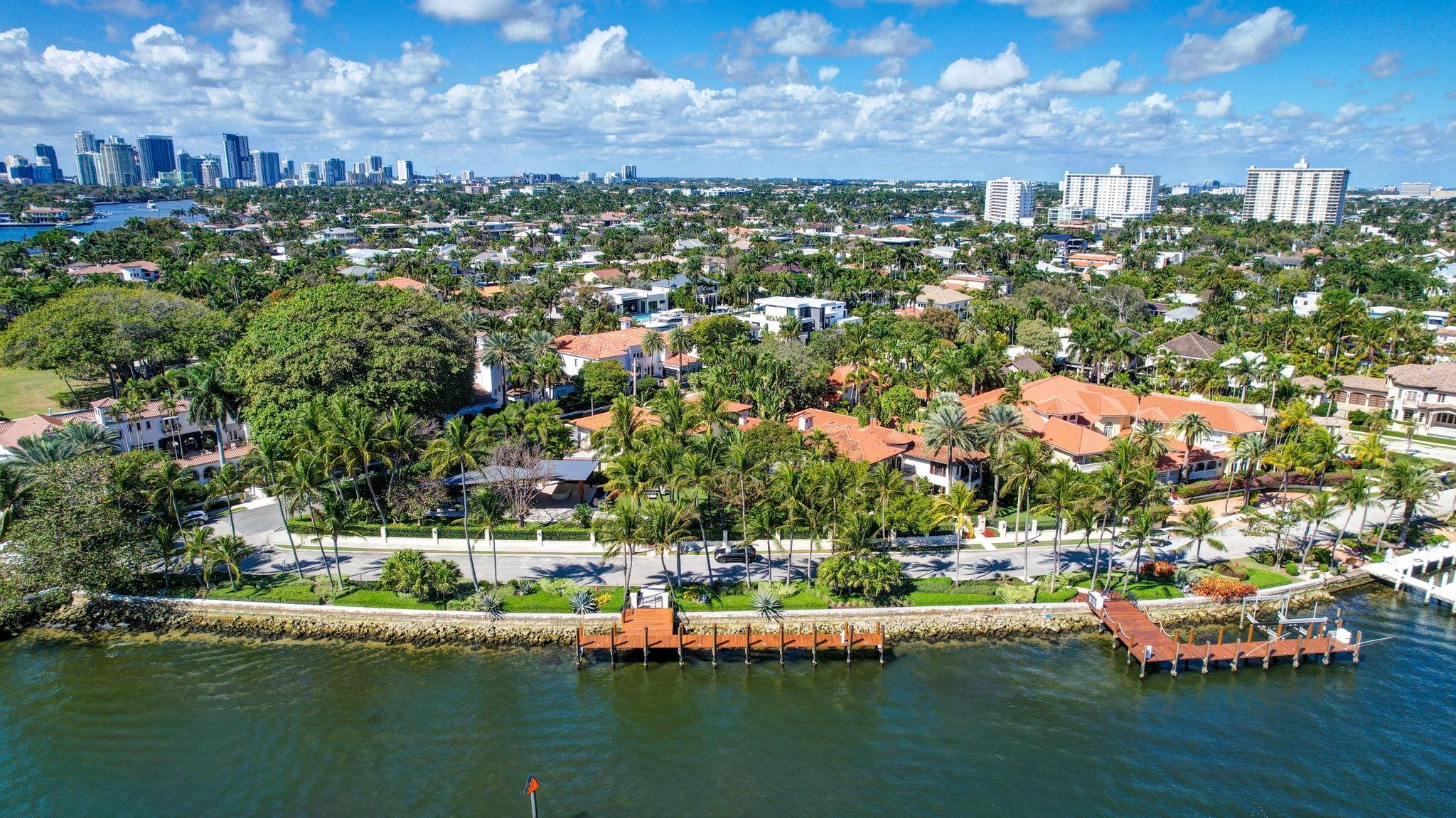 Magnificent two parcel .82 acre Idlewyld waterfront Estate, over 14,000 sf total. Ultimate deep-water compound! 328ft+/- straight-line deeded waterfront (no wake) & two separate docks! Main house entirely renovated & expanded 2012. In 2018, separate guest house added (approx 2,300sf) + 2,500sf pool pavilion, dining area & bar seats 18, caterers kitchen, cabana, gym, office & 3 car garage. Walled & gated for privacy & security, spectacular Award winning grounds & rare tropical landscaping. Two pools & spa add to private resort ambiance! Designed exclusively for boating & entertaining! Timeless Marc Michaels design throughout, custom detailing & high quality finishes. Main house has 2,000sf+/- covered outdoor living area off Chef's kitchen (potential apartment over additional 3 bay garage)