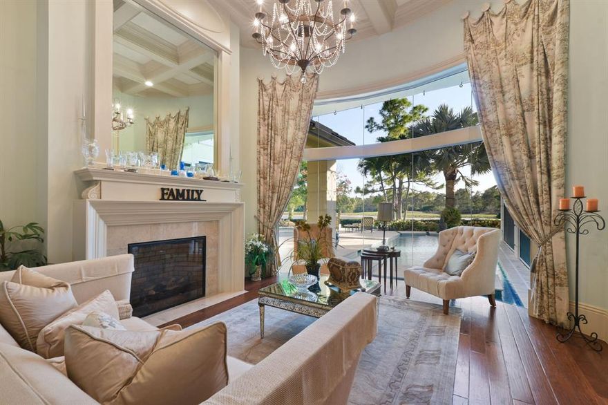 As one enters this home through double mahogany doors your eyes are immediately drawn to the volume ceilings & walls of glass overlooking the pool, yard, golf course, lake & nature preserve. Situated on a private 1/2 acre lot boasting 5 bedrooms, 6 full bathrooms, 2 powder rooms, along with a Movie Theater, Game Room with wet bar, summer kitchen, sculpture garden, 2 story closet in primary, 2 laundry rooms, elevator, multiple bars, fireplace, office & 5 car garage! Marble pavers in the front and back of the estate set the stage for a presence of luxury. High and dry, elevated pad for dramatic views. This home has the perfect floor plan for entertaining.  Medalist Village has a 12 hole Greg Norman Par 3 golf course, restaurant, spa, tennis & gym.  Sellers rep is tenant