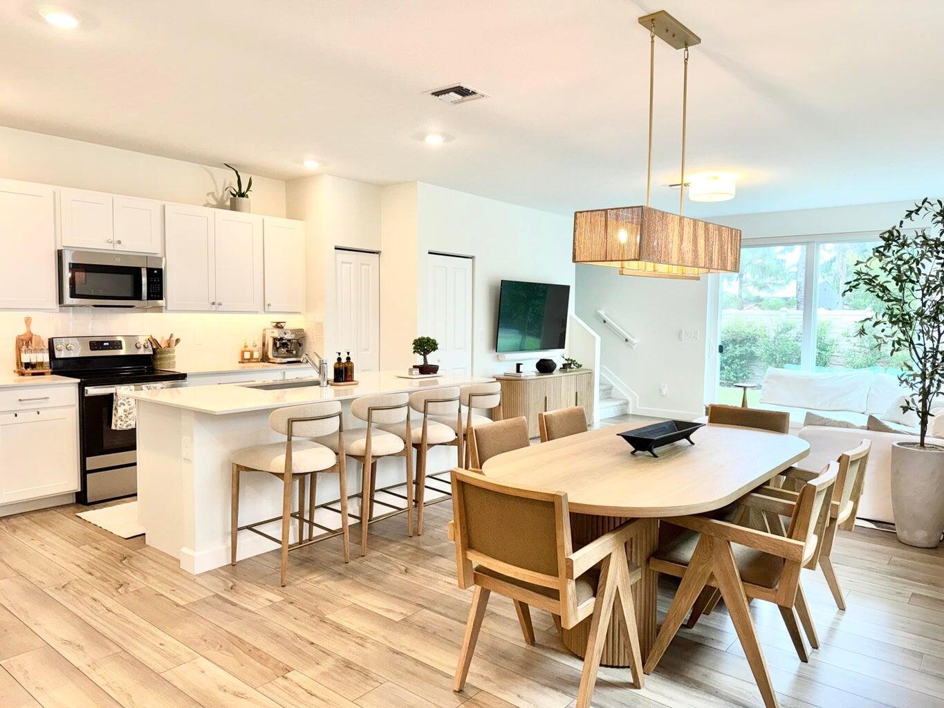 Step into a place that feels like home the moment you walk through the door. This beautifully updated 3-bedroom, 2.5-bath modern townhome with a den and tranquil garden views offers not just space, but peace of mind--now priced to be the best deal in the neighborhood! Built in 2023 and nestled in a prime, central location close to shopping, dining, and major highways, this nearly-new home is perfect for anyone craving style, convenience, and long-term value. Enjoy a bright and airy open floor plan filled with natural light, custom light fixtures, and upgraded finishes that add warmth and elegance. Whether you're hosting friends or enjoying a quiet night in, the spacious living and dining areas create the perfect backdrop.