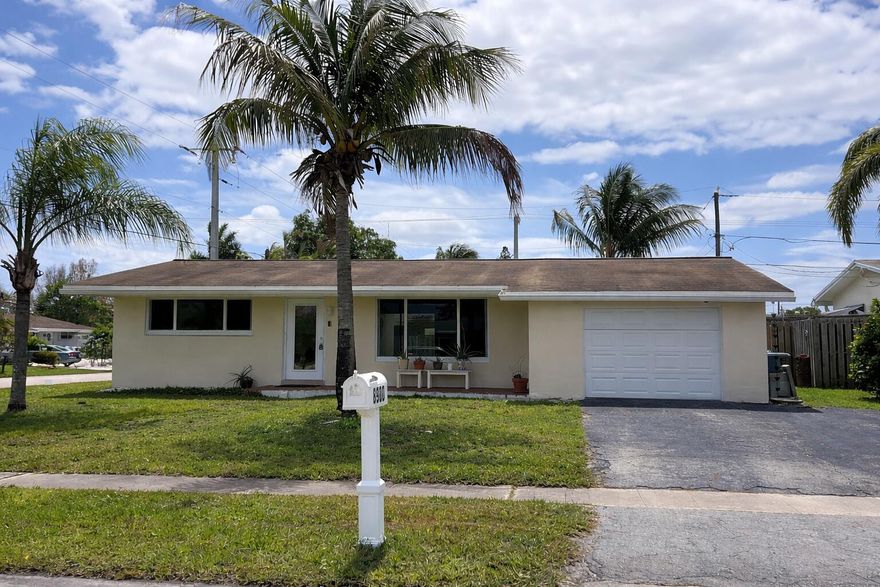 2 bedroom / 2 bath home located on large corner lot with beautiful palm trees. This home features hurricane impact windows & hurricane panels, newer roof (2017), updated electrical, & fenced yard. Interior features wood & tile floors (no carpet), high hat lighting, updated bathroom, & eat in kitchen with gas stove, gas dryer and gas water heater. This home is located in desirable Sunrise Golf Village community with no HOA. Come see this home & appreciate all it has to offer. Priced well to allow for you to move-in and make this house a home.  Great opportunity.