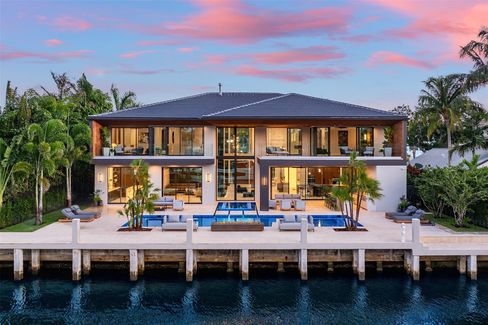 Introducing the crown jewel of Coral Ridge. Hyper luxurious earthy estate meticulously crafted atop one of Coral Ridge’s premier waterfront isles. Behold the ease at which this fully furnished residence seamlessly blends organic stones, wooden hues, and timeless textures into its lavishly landscaped environment.
Extremely functional and flush with an array of modern amenities/features including:
-Italian imported kitchen
-Wine room with self-contained evaporator and glass wine racks
-High ceilings 22’ in the living room, along with a gas fireplace and wall composed of book-matched Sahara Noir marble slabs
-Disappearing sliders creating the full effect of seamless indoor/outdoor living
House will be sold with all furniture, art, rugs, bedding, towels, TV and cameras.