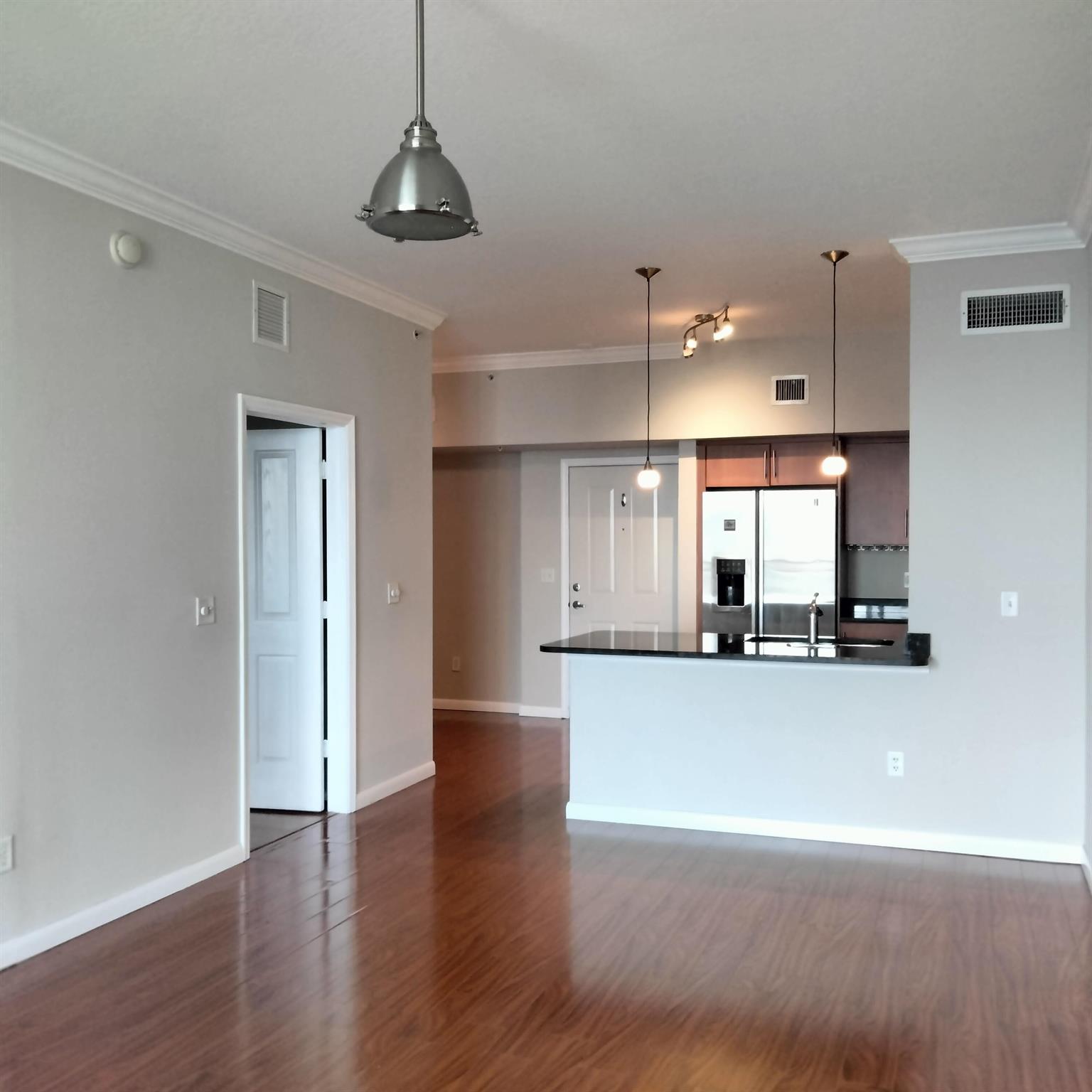 BR/1BTH with DEN, Penthouse Condo with private view on Downtown WPB ! Hardwood floors thru,updated kitchen,lots of natural light, high ceilings, extra space for dining area. 650+ cr.score. Building ''PRADO'' offers full of amenities, great pool area with Jacuzzi Spa, gym and a clubhouse with a big screen TV and a full kitchen. 24/7 manned security to enter building and parking garage. Pets are welcome, water is included in rent. Next to City Place, Clematis,and downtown WPB.