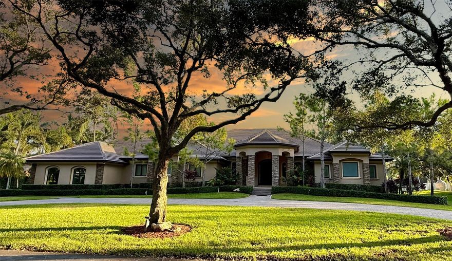 ***THE RIDGE AT LAUREL OAKS... ONE OF DAVIE’S MOST COVETED GATED COMMUNITIES!!!*** 
TUCKED AWAY IN A PRIVATE ENCLAVE OF JUST 18 CUSTOM HOMES, THIS HIDDEN GEM OFFERS AN EXCEPTIONAL BLEND OF LUXURY, TRANQUILITY, AND EXCLUSIVITY. SITUATED ON A PRIME BUILDER’S ACRE WITH LAKEFRONT VIEWS, TOTALING 7,603 SQFT UNDER ROOF W/5,500 SQFT OF LIVING AREA, THIS ESTATE SHOWCASES REFINED LIVING AT ITS FINEST. HIGHLIGHTS INCLUDE A BRAND-NEW FLAT TILE ROOF, FULL-IMPACT GLASS, AND AN EXPANSIVE OPEN-CONCEPT LAYOUT. THE PROPERTY IS ADORNED WITH MAJESTIC MATURE OAKS, FRUIT TREES, AND LUSH/MANICURED LANDSCAPING, CREATING A SERENE CANOPY OF PRIVACY. THE RESORT-STYLE BACKYARD FEATURES A FULL SUMMER KITCHEN, SPARKLING POOL AND JACUZZI, AND PRIVATE BEACH ON THE LAKE—A RARE AND PEACEFUL RETREAT RIGHT AT HOME.