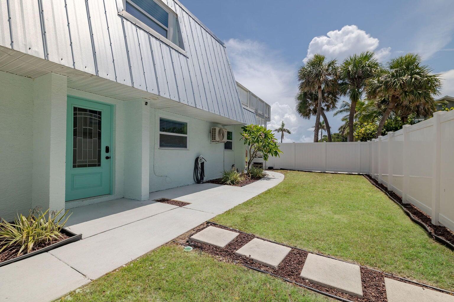 Tastefully coastally furnished 3-bedroom ground-floor unit in a quiet, non-association triplex on gorgeous Hutchinson Island. This rare find offers 3 spacious bedrooms, a full bathroom, and a laundry room with washer/dryer. Enjoy the private fenced entry patio, then step through sliding doors to a rear open patio featuring cozy outdoor furniture, a gas grill, and a fireplace--perfect for entertaining or relaxing. Walk across the street to the beach or stroll to Hutchinson Island's many restaurants, shops, and attractions. With its ideal location, privacy, and charm, this home offers a true island lifestyle. Call today to schedule a tour!