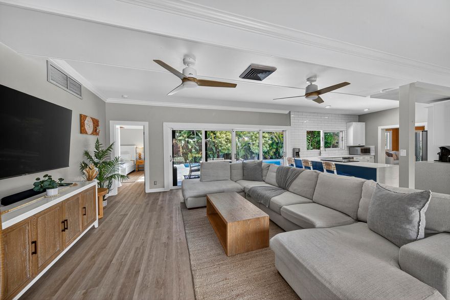 Perched on a ridge and surrounded by lush tropical greenery, this stylish 4 bed, 3 bath Mid-Century Modern pool home sits in the desirable Harbour Inlet—just a short walk to Fort Lauderdale's best beach! Designed for indoor-outdoor living, the home features floor-to-ceiling glass with panoramic views of the new heated pool, marble paver patio, and professionally manicured grounds! The bright, open layout includes multiple seating areas, vaulted ceilings, a central kitchen w/ pass-through to the pool area, and two spacious primary suites on opposite sides—perfect for privacy or guests. Outdoors, enjoy privacy via lush hedges & fencing, generous patio space, and storage sheds. Whether full-time living or a vacation escape, this home offers the ideal blend of style, comfort, and location!