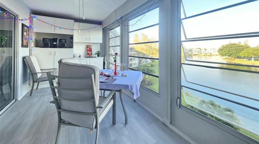 MAGNIFICENT 4th FLR condo w/breathtaking, unobstructed LAKE VIEW! This SPACIOUS, FULLY FURNISHED 1 bedroom, 1.5 bath condo features new vinyl floors thru-out & an updated electrical panel for peace of mind. The primary bath offers a walk-in shower w/glass doors. Ceiling fans in every rm! Enjoy serene water views from an expansive 8’ x 18’ encl patio w/roll up shutters—perfect EAST EXPOSURE  for relaxing or entertaining. Ideally located close to elevator in a well-maintained bldg. Prime loc just steps to clubhouse w/amazing amenities incl gym, movies, theater, indr/outdr pools, sauna, classes, clubs & more! Enjoy RESORT STYLE LIVING in this active, gated community w/24 sec, free busses, heated pools, tennis, pickleball, putting green & shuffleboard. A MUST-SEE OPPORTUNITY! ASSOC. CLAIMS 55+