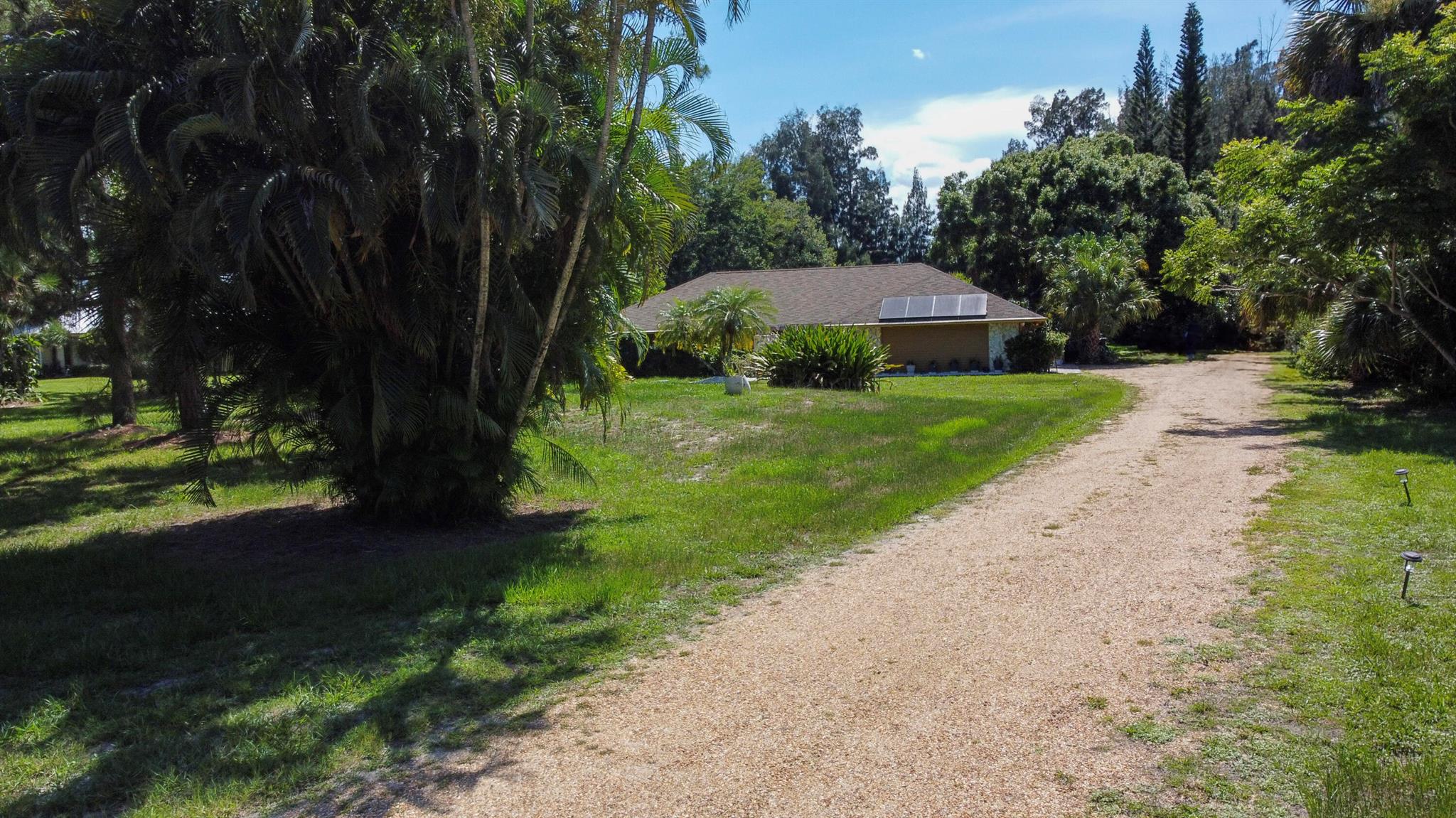 Incredibly RARE opportunity to rent a full home on over an acre of land in Palm City! Located in Crane Creek, a guard-gated community just minutes from I-95 and the Florida Turnpike, this 3 Bedroom, 2 Bathroom home is both spacious and inviting with 2 living areas, a split floor plan, large kitchen, and natural light galore! The main bedroom features an en-suite bath, walk-in closet, and extra office/sitting area while the other two bedrooms and bathroom have their own area across the house. Enjoy all that South Florida has to offer in your large private backyard and enclosed pool, with easy access from both living rooms, the kitchen, and even the primary bedroom! Call me today for your opportunity to enjoy paradise!