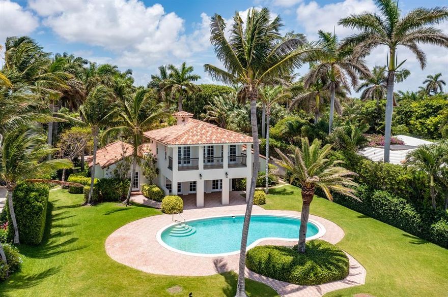 Amazing opportunity to own this very special home located directly on the intracoastal. Behind the gated entry is a private oasis located on a 22,000+ SF lot featuring a private dock, resort-style pool, a separate renovated 1-bedroom guest apartment, and 2-car air-conditioned garage. Breathtaking views of the intracoastal, sailboats, Palm Beach Island, and picturesque sunrises are seen from almost every main room. The master suite encompasses the entire second level. The spacious master terrace and downstairs outdoor loggia are both the perfect place to watch the beautiful sunrises each morning. This spacious kitchen has stunning views of the water, stainless appliances, a commercial gas stove. Enjoy the breathtaking views from this stunning 4 bedroom, 4.1 bath waterfront residence with a 2 car garage, pool & guest apartment. includes French doors opening up to the spacious balcony overlooking the pool and intracoastal. Lush landscaping around the pool provides for ample privacy, and your own private dock extends along the tropical intracoastal waters. A separate structure houses the 2 car garage and delightful 1 bed, 1 bath studio upstairs.
