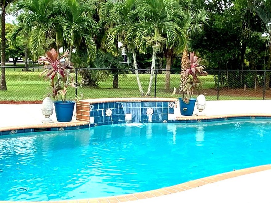 This home is located on 2 paved streets. Empty lot on the east side. Canal located behind the home adds privacy from neighbors. Storage shed 20x15 anchored to ground with hurricane ties. 30 AMP for RV hook up. New AC 3 month old. Water heater 4 yrs old. New refrigerator and stove. Septic tank drained 2 yrs ago. Chlorine pool with salt hookup available. Large driveway 2 yrs old. This home also was built with Aluminum studs. 3,000 sq ft open pool deck fenced in. Mother in law/maid suite attached to house. Suite includes 1 bedroom, 1 full bath, living room and kitchenette. Private entrance into living area and cabana door to pool.  Large closed in Florida room with AC and French doors opening to the pool and spacious deck. Large brick wood burning fireplace (2sided)  located in the Great Room