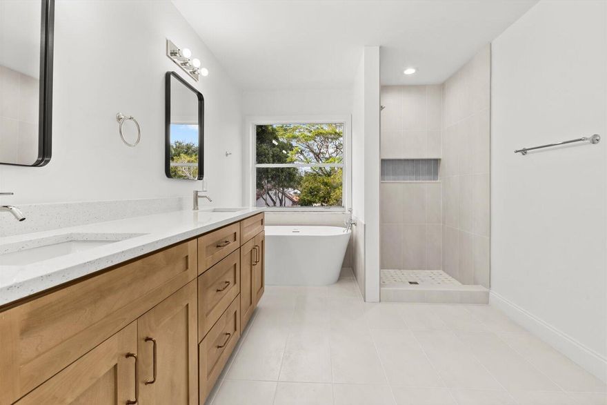 Showings must be scheduled with Showingtime. Exquisite 4/2.5 residence with brand new Tile roof! Renovated in 2025. The gourmet kitchen boasts luminous Calacatta quartz countertops, bespoke soft-close shaker cabinetry, and premium high-end finishes, designed to inspire culinary excellence. Luxurious spa-inspired bathrooms feature sophisticated tile work, free standing tub, gorgeous vanities, and contemporary fixtures, elevating daily rituals to a serene escape. Impeccable waterproof laminate flooring, freshly painted interiors and exteriors, and brand-new, top-tier appliances blend style with functionality. Enjoy effortless access to I-95, premier shopping, and dining. This residence seamlessly blends modern luxury with timeless comfort.