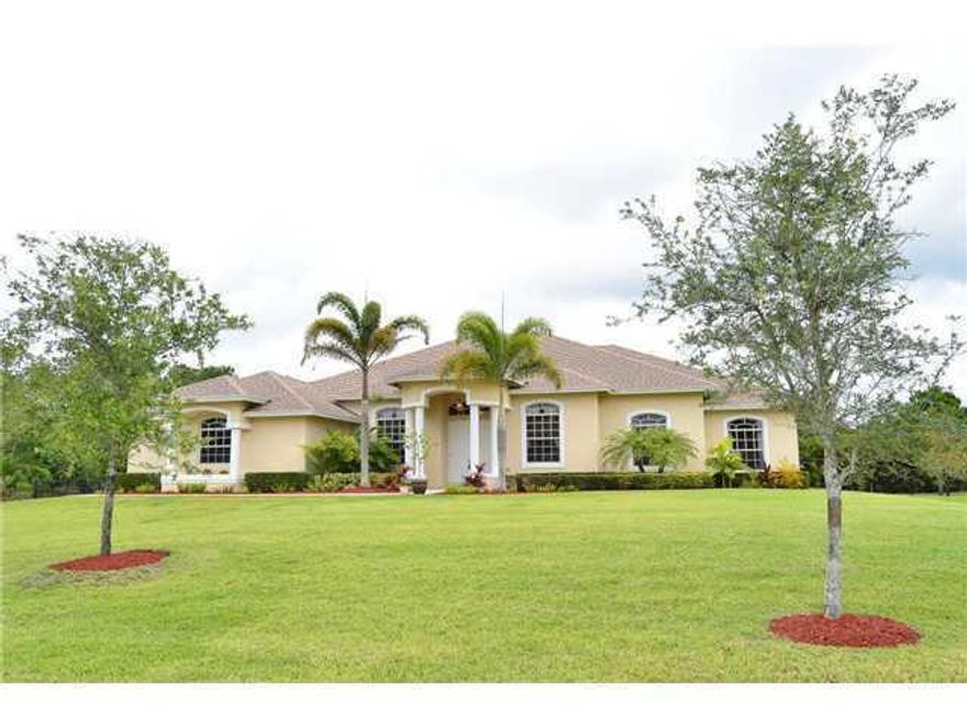 It doesn't get any better than this! Incredible 4 bedroom (plus den) luxury home located in the Acreage on over an acre of property. This home boasts a wonderful split floor plan with incredible features including all tile floors. Built in 2007, this home has a long list of upgraded featuresand benefits. Volume ceilings, 8 foot doorways,overly spacious family room, living room and dining room and a must see kitchen featuring wood cabinetry, granite counter tops, stainless steel appliances including built in double ovens and a large island with vegetable sink and pantry. The split floor plan allows full privacy for the master suite which boasts a large reading area and an incredible bath. This property also benefits from 3 additional bedrooms ( A total of 4/plus den) one also featuring another private bath. Enjoy your morning coffee enjoying the plush grounds on the oversized covered and screened lanai. The home is located on a 209" x 239" property (1.14 acres) and is on a private roadway ideal for horses...with other fine residential homes! The Bose speakers in the family room and lanai remain with the home along with all window treatments, ceiling fans and the beautiful paddle fan in the great room. The rear of the property is fully and discreetly fenced so you have the benefit of the fencing while the rear fencing is hidden away. Owners added additional ceiling insulation...high efficiency!   Brand new Pressure Tank for Well installed 6/2018 and brand new sprinkler motor added 6/2018! This is a must see residence...in a terrific area and with immediate occupancy available.