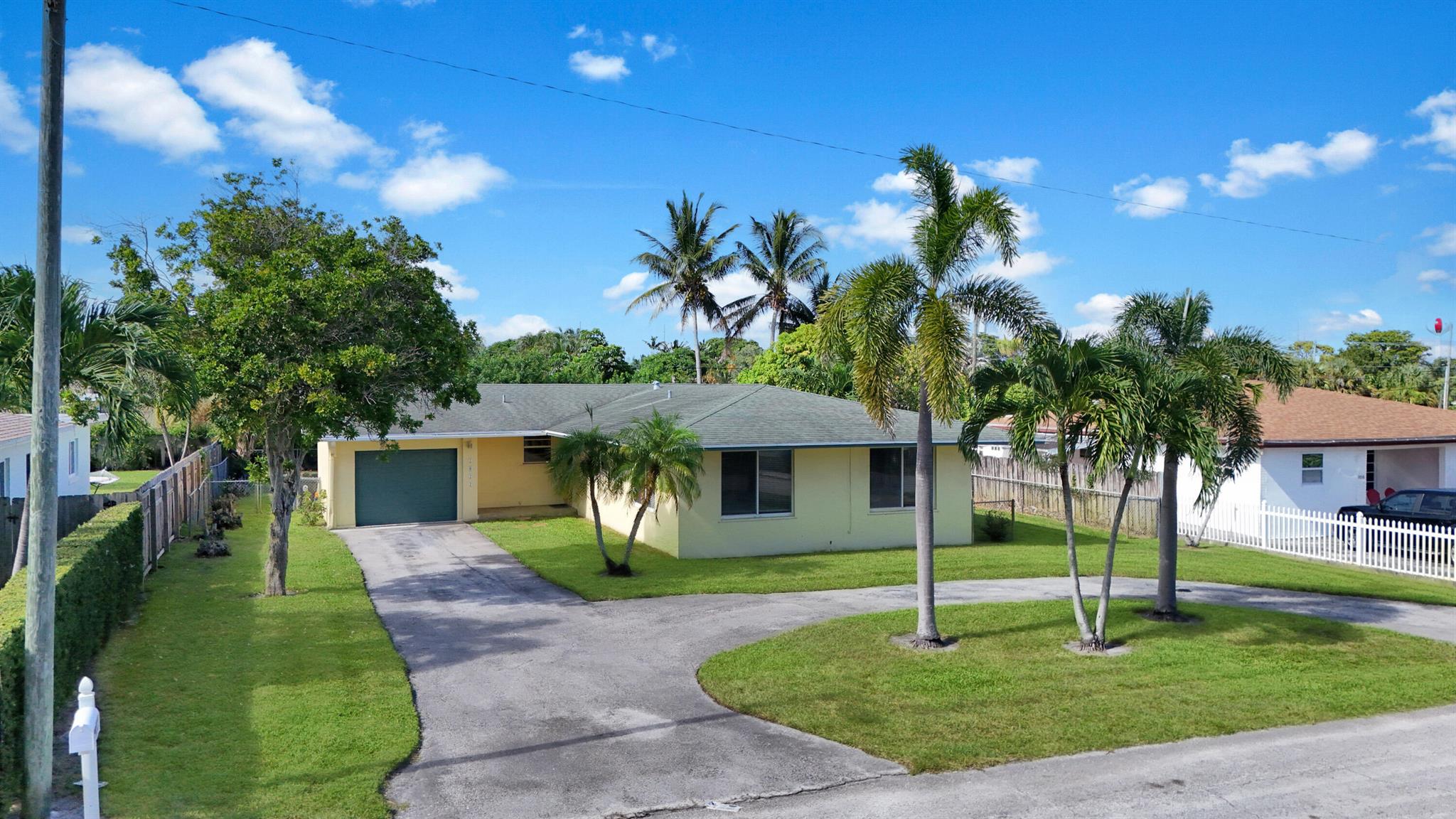 Well maintained 3 bedroom, 2 bath home short walk to Lake Osborne. Brand new kitchen with large pantry and dining area. Living room has a bay window, large sliders to the outside patio and (a fireplace, which is non-working). Beautiful terrazzo floors throughout. Lots of storage. One car garage. Partially fenced huge yard. A/C 2017. All measurements are approximate.