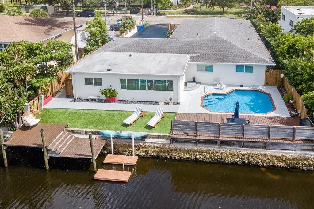 Currently operating as an Airbnb, this waterfront 4-plex in the heart of Wilton Manors features BONUS studio--can be rented separately for a total of 5 units. Full remodeled w/ updated granite & stainless steel kitchens & baths including a gorgeous backlit quartzite kitchen in the 3/2 unit which would make a lovely owner's suite. Tile floors throughout, ample storage, central A/C, upgraded laundry room accessible to all units, lovely back with floating dock & sparkling pool! Four separate meters. . Ideally located on a quiet street, but only blocks from lively Wilton Drive so you can enjoy the serenity of Wilton Manors city park (w/ tennis/basketball courts/playgrounds) & also walk to restaurants, shops & nightlife!