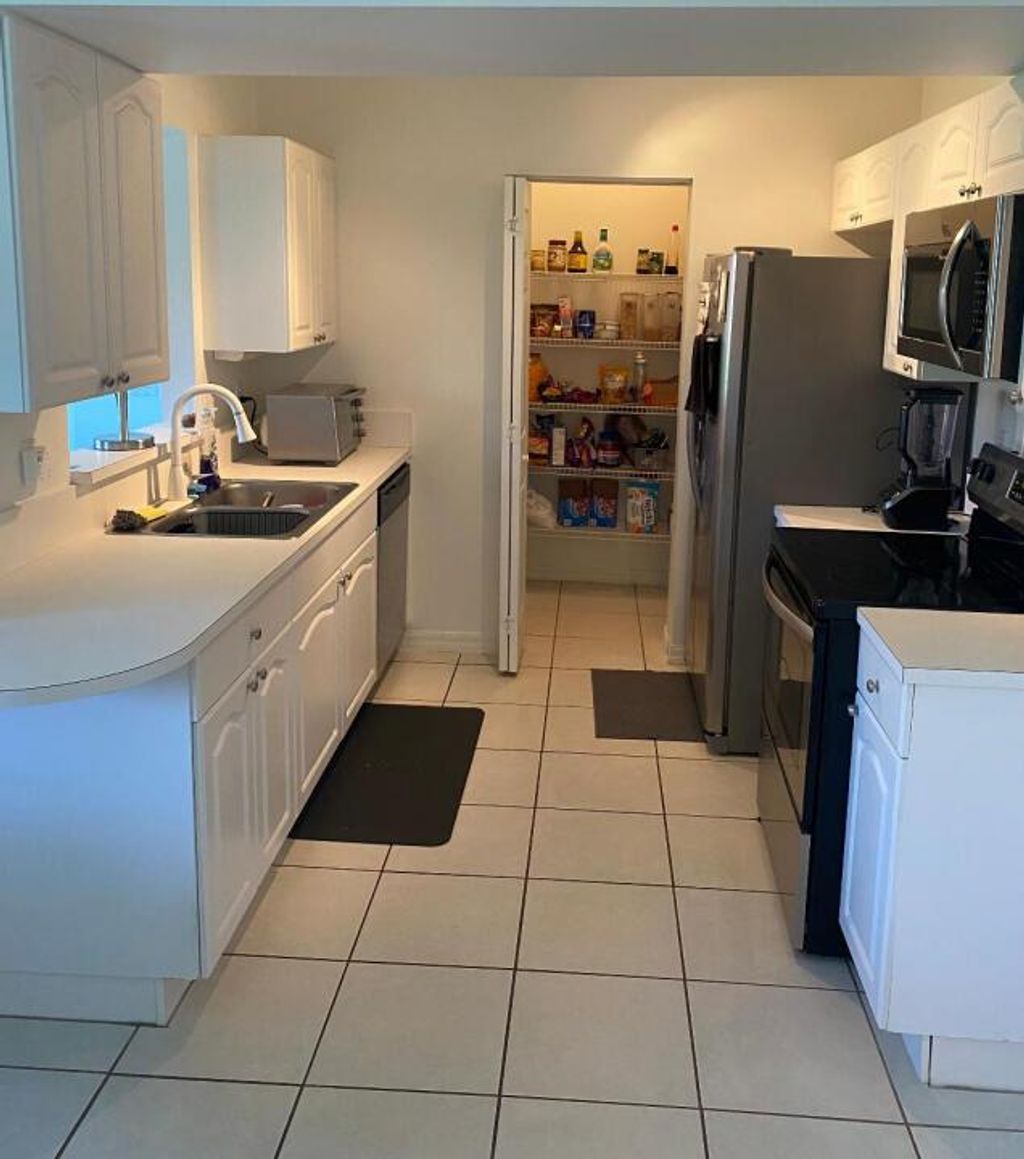 Photo of 1094 Via Jardin, Riviera Beach, FL 33418 (MLS # R10975437)