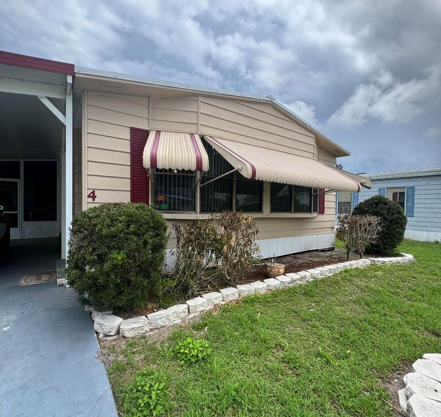 2 bedroom 2 bath home in the 55+ Spanish Lakes Country Club Village community. This home sits in a very quiet cul-de-sac near the park entrance. The home backs up to a wooded area.  The home has a new roof 2025. New floors of laminate and carpet. New vanities in bathrooms. This home is being sold furnished. The home has 2 sheds.  Lawn care, trash removal, and golf are included in the lot rent. 2 pools, tennis, pickleball, bocceball, and shuffleboard. club house and much more.