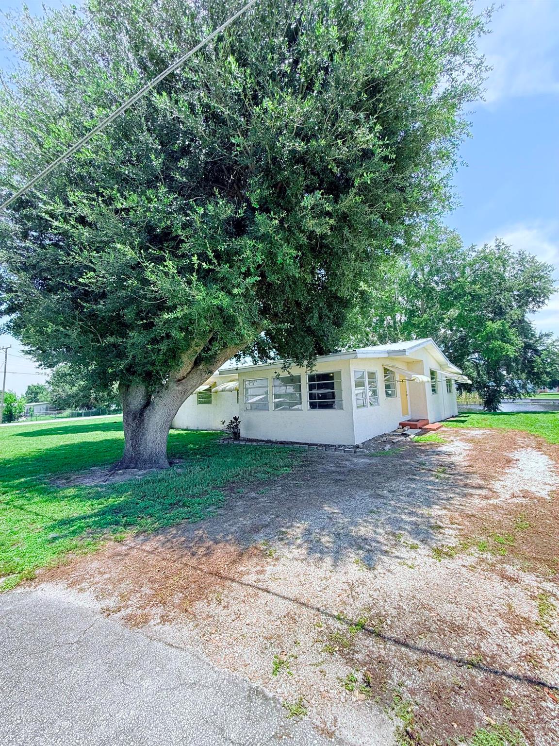 This beautifully renovated 3-bedroom, 1-bath home is the perfect lakeside retreat with direct access to Lake Okeechobee and your very own boat slip! Inside, you'll find a bright and spacious layout featuring a huge family room, enclosed porch, separate laundry room, and a modern kitchen with all appliances included. Every bedroom offers oversized closets and there's plenty of storage throughout. Whether you're dreaming of a peaceful retirement spot or a cozy family home, this move-in ready beauty offers comfort, convenience, and that relaxing lake life vibe!