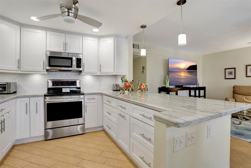 BEAUTIFULLY RENOVATED CORNER IN SOUGHT AFTER LYNDHURST! IMMACUALTE! HURRICANE IMPACT WINDOWS & DOOR W/ ADAPTABLE SCREEN OPENING FOR THOSE DELIGHTFUL WINTER BREEZES. LOVELY PLANTATION SHUTTERS, NO POPCORN, OPEN CONCEPT KITCHEN WITH GORGEOUS MARBLE COUNTERTOPS & ELEGANT BACKSPLASH. NEWER SS APPLIANCES, AC & WATERHEATER. SHORT WALK TO THE CLUBHOUSE FROM PATH ON THE RIGHT OF THE BUILDING! TILED FLOORS THROUGOUT. 5 STAR CLUBHOUSE. PICKLEBALL, TENNIS, SHUFFLEBOARD, BILLIARDS, PING-PONG, YOGA, FELDENKRAIS, TAI-CHI. YOU NAME IT, WE HAVE IT! STATE OF THE ART GYM W/ FITNESS CLASSES EVERY DAY. BUSES RUN FOR YOUR CONVIENECE IN AND OUT OF THE COMMUNITY. CVE IS A GATED COMMUNITY W/24HR SECURITY, LOCATED 3.5 MILES FROM GORGEOUS DEERFIELD BEACH, CLOSE TO GREAT SHOPPING AND EATERIES. OWNER VERY MOTIVATED!