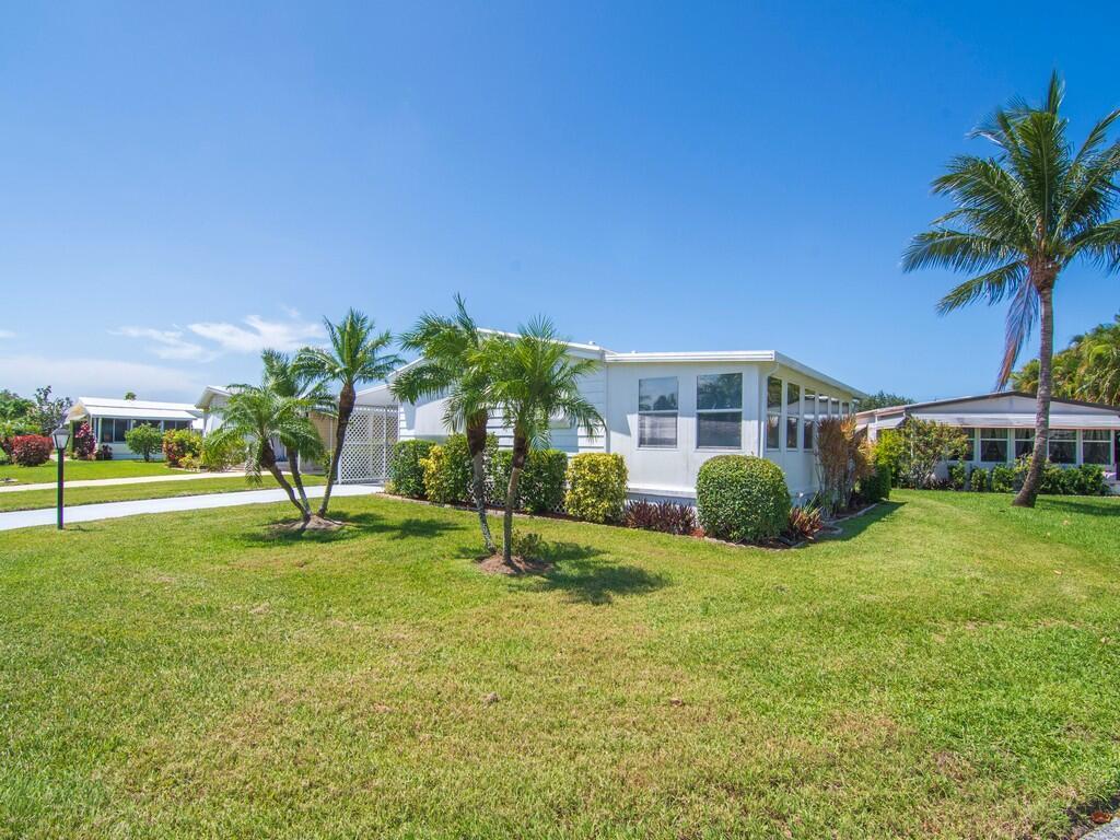 Welcome to 66 Pinelake Village Blvd, Jensen Beach, FL -- a charming double-wide home nestled in the heart of a vibrant 55+ community just minutes from the ocean. This beautifully maintained 2-bedroom, 2-bath home comes completely furnished and brand-new flooring throughout, giving the interior a fresh, modern feel. A new roof ensures peace of mind for years to come and the new vapor barrier adds an extra layer of protection and energy efficiency beneath the home. Situated on a spacious corner lot, this home offers both tranquility and convenience. Enjoy the perks of a fully equipped kitchen, and a cozy porch perfect for morning coffee or evening relaxation. Lot rent is $765 per month and includes cable, trash removal, recycling and all the amenities of the clubhouse.