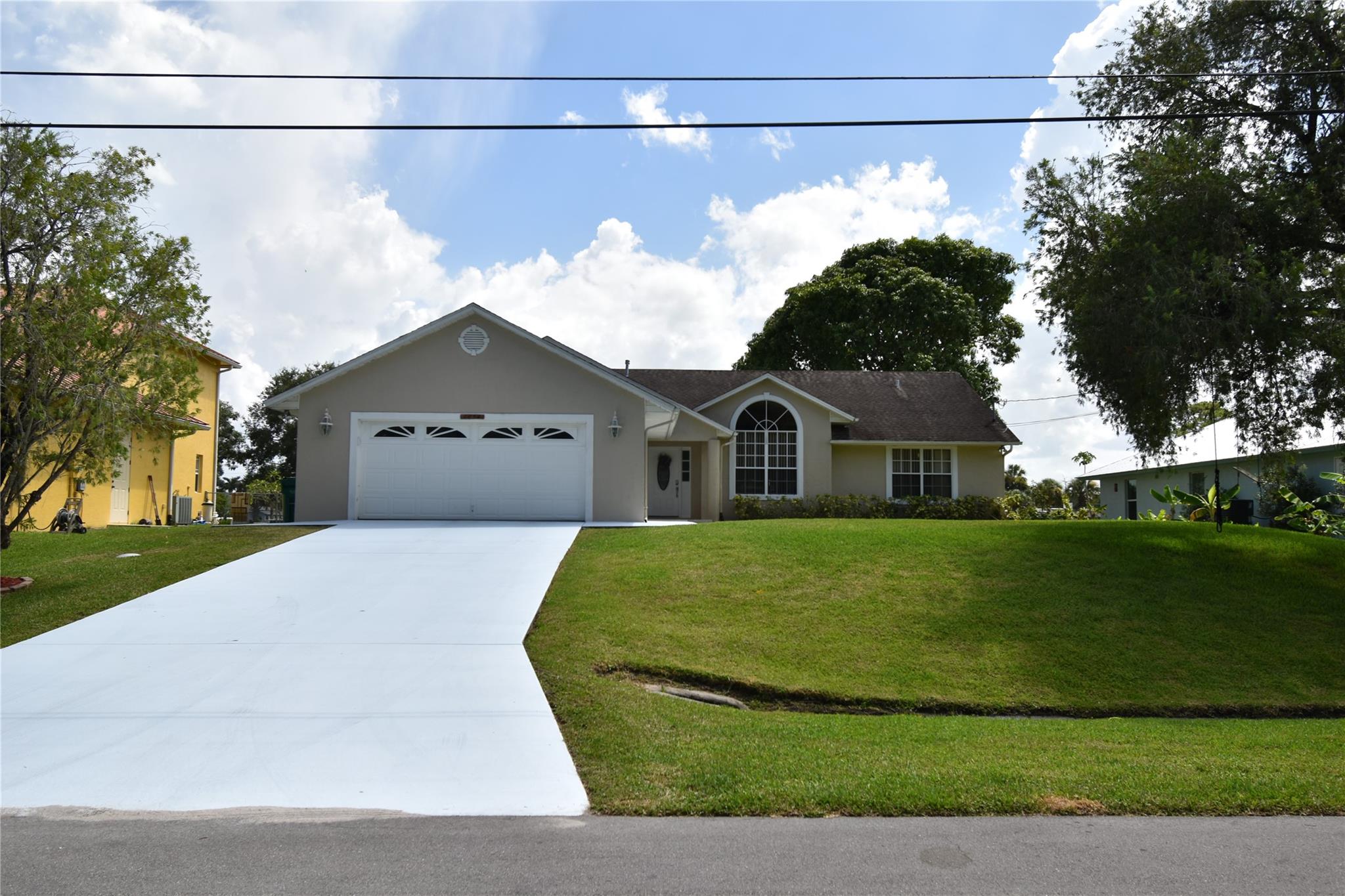 Experience waterfront serenity in this oversized-lot gem, nestled in one of Port St. Lucie’s most coveted neighborhoods. Enjoy peaceful canal views from your private dock or entertain in a lush, fenced backyard with plenty of space for gatherings. Inside, soaring vaulted ceilings, crown molding, wainscoting, and plank accents blend elegance with warmth. The open split floor plan flows to a chef’s kitchen with granite countertops, stainless appliances, breakfast bar, nook, and walk-in pantry. Retreat to the primary suite with water views, patio access, spa-like bath, and dual walk-ins. Boat/RV-friendly, minutes to shopping, dining, entertainment, beaches, and major highways — where beauty meets lifestyle. A rare find ready for your personal touch! Schedule your showing today.
