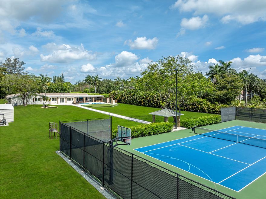 Pool, tennis, basketball & golf! 5060 Thoroughbred Lane was re-designed from the ground up with supreme focus on natural light, bright interiors & ample green space. Constructed utilizing quality materials and best-in-class brands. Specs include 4BR/3BA, spacious owner’s suite w/spa-style bath, playroom/office, complete gym, full bar, glass wine room w/ walnut/stainless fittings, chef's kitchen ft. Wolf 60" gas range, Subzero refrigeration, Miele dishwashers, walk-in pantry/laundry center. Outside boasts immense privacy, pavered walkways, lighted tennis/basketball court w/viewing pavilion, putting green, chipping zone, 32x16 sparkling pool, full summer kitchen (grill, sink, refrigerator, ice maker, tv, music, fireplace). Impact glass/full-home generator complete this world class existence.