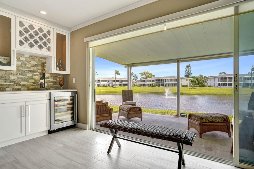 Welcome to this luxury 1st floor corner lakefront retreat, meticulously renovated and updated for modern living. This spacious residence features 2 bedrooms and 2 full bathrooms across an impressive 1,167 sqft. Enjoy seamless indoor-outdoor living with sliding glass doors leading to a 160 sqft open covered patio overlooking the serene lake. The contemporary open kitchen boasts soft-close white cabinetry, expansive granite countertop and a dedicated coffee bar - making it perfect for culinary enthusiasts.The stylish interior is enhanced by porcelain tile plank flooring, shaker-style wainscoting and crown molding . Relax in the inviting living room with a built-in media center with an electric fireplace or unwind at the elegant wine bar. Both luxurious bathrooms feature walk-in showers.  Renovated Lakefront : first floor 2/2 corner luxury retreat! Experience the epitome of lakeside luxury in this meticulously renovated first-floor corner residence at the Pines of Delray West. Enjoy serene lakeside living in this 1167 square feet haven offering breathtaking lake views and abundant natural light from its southern exposure. This gem seamlessly integrates contemporary design with tranquil outdoor living - with sliding glass doors leading to a 160 square foot covered patio overlooking the tranquil waters. There's also an additional 13' x 7' covered patio just outside your front door, perfect for year-round enjoyment. Inside,the contemporary tone is set with 31.6 inch X 8 inch porcelain tile plank flooring and modern wall colors. And a touch of sophistication is added by the elegant 4-foot high shaker-style wainscot panels and crown molding in in the living room/dining area and the entrance hallway. The contemporary open kitchen is one of the highlights of this residence with soft- close white cabinetry, 24 feet of granite countertops, granite backsplash, a dedicated granite top coffee bar and an impressive chair height breakfast bar. Included within the cabinetry are pull-out spice racks on both sides of the range as wells a serveral pull out drawers.  There's also a 27" wide and 9" deep stainless steel sink, a separate pot filler faucet,  a 12" x 8"  Franke 19 gauge stainless prep sink, instant hot water dispenser as well as stainless steel appliances including a convection range with a Zephr chimney- style range hood vented to the outside. The 29 foot long living room/dining area boasts a built-in media center with a mounted (but recessed) large screen television,a fully recessed built-in linear electric fireplace--which can be used with or without heat to create a cozy atmosphere year round.* At the rear of the living room is a wine bar with a quartz countertop, tumblestone back wall, 2 cabinets, a wine rack above and an undercounter Kitchenaid 46-bottle "wine cellar" refrigerator*.The two luxurious bathrooms include a frameless walk-in master shower with a built in tile seat and a walk-in shower in the guest bathroom. Both showers have 2 ft x 1 ft tiles on the inside walls and the guest bathroom walls have white shiplap overlapping panels in a horizontal format.* OTHER HIGHLIGHTS INCLUDE:*All contemporary wall colors.*All smooth surface ceilings.*All 5  inch tall baseboards.*IMEX soft close hinges on all cabinetry.*Crown molding in the living room and dining area.*Three remote controlled paddle fans. *12 recessed lights (kitchen:8; living room:3; guest bedroom:4.EQUIPMENT**2024 RHEEM WATER HEATER (2024) M#: XE38S06ST38U1: Performance 38 Gallon capacity; two  3800-Watt Elements;  automatic thermostat which keeps the water at the desired temperature;  premium grade anode rod providing long lasting tank protection; plus a temperature and pressure relief valve.**2024.RHEEM AC CONDENSER   ENDEAVOR M# RA14AZ30AJ1NA:  2.5 Ton Capacity; 14.3 SEER2 ; 11.7 EER2; 30,000 BTU/h; R-410 Refrigerant; 2024 DIVERSITECH HURRICANE PAD for condenser-Wind Zone T-Class** 2024 RHEEM AC HANDLER  M#  RB2TZ3621STANMJB07:   2-stage  Constant Torque motor (ECM);  MultiFlex coils; Sturdy steel construction with 1 inch of foil faced insulation;  Evaporator  constructed of aluminum fins bonded to internally grooved aluminum tubing.** 2024 SQUARE D AIR CONDITIONING ELECTRICAL DISCONNECT BOX: A CODE-REQUIRED device that is used to safely disconnect electrical power from an air conditioning unit for maintenance purposes. ** 2024 HONEYWELL HOME THERMOSTAT: **GE LOAD CENTER (ELECTRICAL PANEL):  M# Powermark Gold: 100 amp service, a galvanized steel rust-resistant box, and a tin-plated copper bus bar for high conductivity.** 2 KOHLER TOILETS  M# F78274/l #F78275: Highline Arc Product line: Chair height elongated seating;  class 5 canister flush technology and 1.28 GPF.** APPLIANCES: GE PROFILE REFRIGERATOR M# PSC23PSS0: Arctica Product Line: 22.6 Cu. Ft. Stainless Steel Side-By-Side Refrigerator; 14.23 cu.ft.refrigerator section, 8.34 cu.ft.freezer section ; CustomCool Technology and an integrated Ice System.** KITCHENAID "WINE CELLAR"  REFRIGERATOR:  24" undercounter wine cooler refrigerator with glass door and full-extension wood-front racks with a 46 standard Bordeaux bottle capacity; 2 Temperature-Controlled Zones that let you separate reds & whites to store at desired temperatures;  LED lighting that illuminates the interior without    opening the door; and a temperature monitoring system.** GE PROFILE RANGE M#l: JS968SOF4SS: True European Convection with Precise Air System; a 4.1 cubic foot oven capacity;  black on black glass ceramic smoothtop and 5 heating elements with different size choices** ZEPHYR RANGE HOOD:  30" Chimney Style Stainless Steel  Hood with 5-Speed/600 CFM Blower;  ICON Touch Controls;  LumiLight LED Lighting; Aluminum Mesh Filters; and Airflow Control Technology** SHARP CAROUSEL BUILT-IN MICROWAVE.** GE PROFILE DISHWASHER M#PDW7880J001SS: Full Console Dishwasher with 6 Automatic Cycles, Fold-Down Tines in Lower Rack ; 16 Place Settings capacity; Touchpad controls; Adjustable upper rack; and Delay start option.**INSINKERATOR DISPOSAL  M: Badger 500-1:   1/2 HP Garbage Disposal with 26 oz grinding  chamber, heavy-duty Dura-Drive induction motor; and galvanized steel grind components.**KENMORE WASHING MACHINE AND DRYER M# 417.99570150: Relocated from the kitchen to its own laundry closet with 2 way wall drawers into the master bathroom --sort of a horizontal laundry shute.*** 2026 MONTHLY MAINTENANCE FEE: $599 -this ncludes water & sewer, fiber optic cable, in-unit WIFI (internet access), fully funded reserves and usage of all recreational facilities. The association also repairs and replaces roof and paints the exterior of buildings. Note: all roofs were replaced in 2023-2024, all building exteriors were just painted in 2021, the city maintains the roads and street lights and the clubhouse is not in need of renovation.** 2025 ANNUAL REAL ESTATE TAXES:  $3492  (without exemptions): In Florida property taxes are paid in arrears and the 2026 bill isn't available until Nov 2026. As a resident of the Pines of Delray West you are eligible for a  "City Resident Downtown Parking Permit"that allows for free parking in designated areas; and for beach parking you may be eligible for a  Senior Beach Permit.** BUYER GUIDELINES: At least 1 approved occupant must be 55+; approved co-occupants must be 18+, but can only be in residence when a 55+ approved occupant is in residence at the same time;  However, an under 55 adult can be the sole purchaser of unit if the intent is ,for example, for their 55+ parent(s) to  to live in. Overnight parking is limited to automobiles and SUVs; after 18 months of ownership owners are eligible to lease out their unit (approved leases must be for a 4 month minimum) and only one lease is allowed per 12 month period);** The above information is not warranted nor guaranteed as 100% accurate. It is subject to inadvertent error, omission, miscalculation, misinterpretation and misinformation. It has not been independently verified that all the features