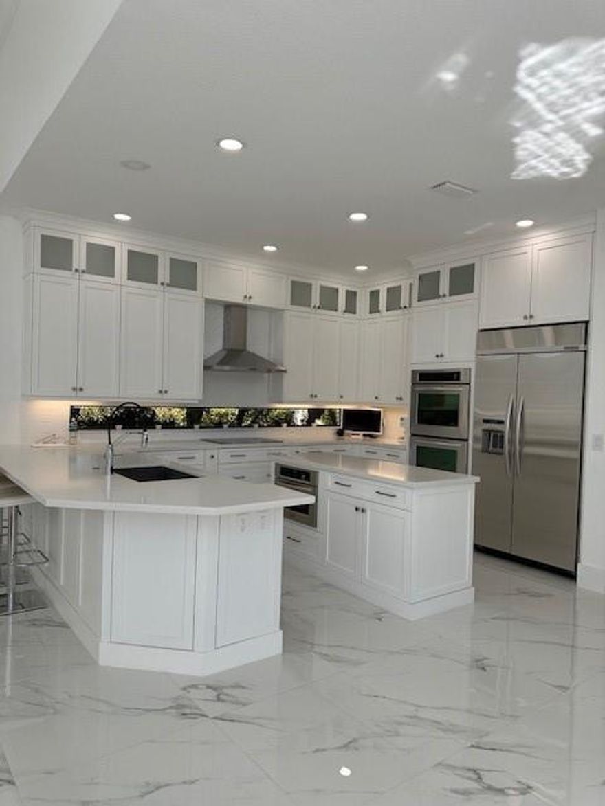 Model-perfect 5 bedroom, 4.5 bathroom w captivating views of the rolling fairway & tranquil lake, creating a picturesque setting. The home showcases a chef’s kitchen appointed w state-of-the-art stainless steel appliances, gas range, farmhouse sink, double ovens & exquisite quartz countertops. First-floor primary suite & guest bedroom, marble & hardwood flooring, w soaring volume ceilings that enhance the home’s light-filled ambiance. Nestled on a quiet cul-de-sac, surrounded by lush, manicured landscaping that ensures both privacy and serenity. Outdoors, enjoy resort-style living w a fully equipped BBQ kitchen, sparkling saltwater pool. Elegant crown molding, hurricane-impact windows, newly painted exterior and newer driveway. Every detail reflects exceptional pride of ownership.