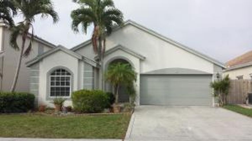 Lovely home in the heart of Wellington! Come fall in love with this 3 bedroom, 2 bath, 2 car garage home. Features include an updated Eat-in Kitchen complete with maple cabinets with pull-out shelving and neutral Corian countertops, Master Bdrm with walk-in closet, updated vanity & glass shower doors and a relaxing Roman tub; beautifully updated secondary bath, vaulted ceilings & ceiling fans throughout, and an extended covered patio with screen enclosure to enjoy the quiet, private back yard. Newer A/C and garage door opener. Attractive stamped concrete tile on the front porch and patio. With top-rated Wellington schools and a sought-after location close to everything, this well-kept property is a great place to call home!