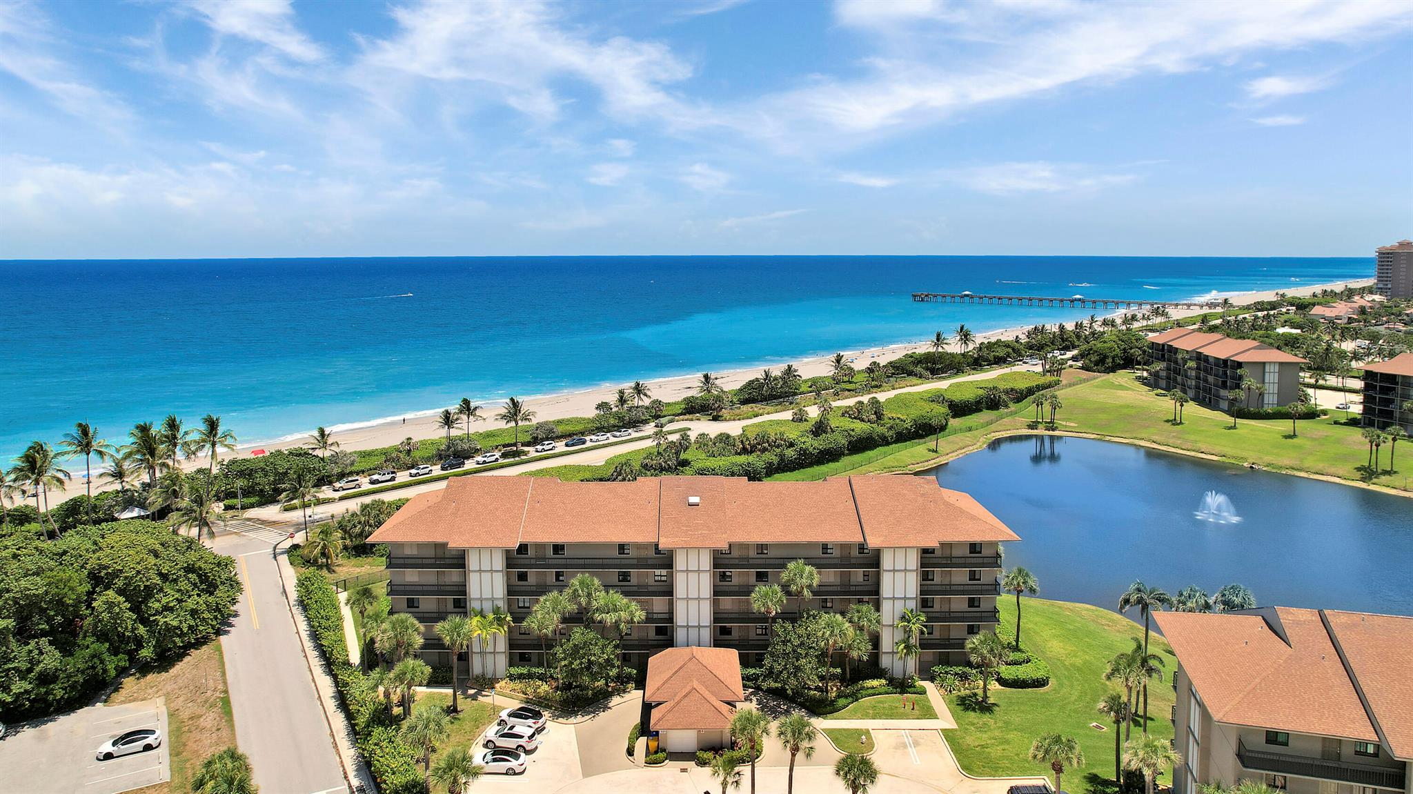 Experience coastal living at its finest in this stunning, fully furnished, turnkey 2-bedroom, 2-bath oceanfront condo in 'Ocean at The Bluffs South' on Jupiter Beach. Perched above the turquoise waters of Jupiter's pristine shoreline, this beautifully renovated residence offers breathtaking ocean views and a lifestyle most only dream of. The upgraded kitchen and bathrooms feature premium cabinetry and custom storage solutions, while the foyer showcases elegant woodwork that radiates coastal charm. A versatile bonus space off the laundry room is ideal for a guest bed, office, or extra storage. Peace of mind comes with impact glass sliders, as well as a new air conditioning system installed in 2024. The furnishings & accessories are perfect for each space, making a move here easy!