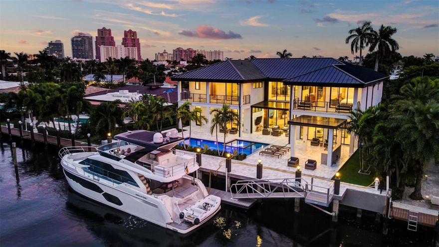 An extraordinary contemporary (NOW OFFERED TURNKEY) 100ft deepwater residence exceeds expectations! Extensive custom upgrades must be seen to be appreciated & ultimate yachtsman's amenities set this home apart! Almost 8,400sf total! 1st level: expansive, open concept entertaining & living areas flow outdoors, Chef's kitchen, formal dining area, one of two primary suites-all water/pool facing, guest bath, elevator, boat storage room, laundry room, pool access cabana. 2nd level presents beautifully: 3 spacious secondary bedroom suites, all custom baths & closet systems, glass enclosed home office/gym. Ultra-luxurious primary suite offers separate spa baths & dressing rooms, private balcony. Multiple balconies, covered terraces, Summer kitchen gazebo & floating dock create a resort ambiance.