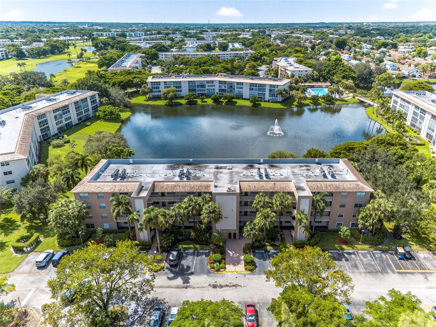 FIRST FLOOR — COMPLETELY RENOVATED LAKEFRONT HOME that will satisfy the most demanding buyer! Step inside to high-end finishes throughout: PREMIUM stainless steel appliances, CUSTOM CABINETRY,  high gloss tile flooring, and elegantly REMODELED BATHROOMS. The enclosed patio is FINISHED WITH AC and IMPACT GLASS so you can enjoy lake views in year-round comfort! Generous bedrooms and large closets provide plenty of storage. Located in Wynmoor, this home includes access to outstanding 55+ community amenities: golf, a 50,000 sq. ft. clubhouse with dining options, pickleball courts, courtesy bus service, fitness and social programs — everything you need for an active, resort-style lifestyle. Don’t miss this move-in ready lakefront gem.