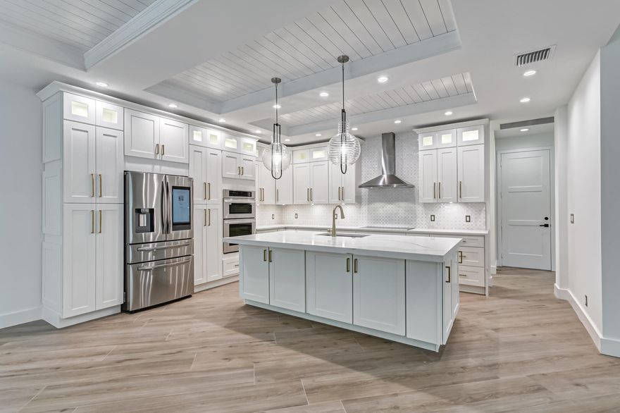 Masterfully designed, this exquisite home has been COMPLETELY renovated with impeccable craftsmanship throughout every detail. Privately nestled in the exclusive enclave community of REGENTS PLACE, this single-story residence is ideal for today's contemporary lifestyle. This reimagined home was enlarged to allow for nearly 2,100 SF and features 3 bedrooms including incredible master suite, 2 full bathrooms plus powder room, 2 car garage, separate living and dining rooms, expansive kitchen surrounded by all new impact windows and doors. From the moment you enter through your private gate, this inviting home feels like your own exclusive paradise. Designed with precision and perfection, this exquisite open floor plan is adorned with soaring ceilings, stunning Woodville natural tile flooring, elegant formal dining accented with dazzling light fixture, with outdoor access from your floor to ceiling impact sliders. Oversized living room completely re-designed with custom bar, Quartz counters and glass cabinetry, and built-in temperature-controlled wine refrigerator for luxurious living and impressive entertaining.
Breathtaking kitchen suitable for a culinary chef! Meticulously designed with hand-crafted detailed ceiling that flow seamlessly from the dining area to your gourmet kitchen. Perfectly equipped with an abundance of custom cabinets, soft-close drawers and interior LED lighting, decorative glass and crown molding, Gold Quartz countertops and decorative tile backsplash, top-of-the-line LG stainless steel appliances include oversized French Door refrigerator, decorative hood accents the 5-burner cooktop, microwave, and convection wall oven. Exquisite waterfall designed Gold Quartz countertops surround the oversized island/breakfast bar illuminated by dazzling pendant lighting and LED hi-hats.
Grand master suite with huge walk-in closet leads into luxurious master bath equipped with elegant marble tile that extends into oversized shower, frameless glass shower with Rain shower head, expanded custom vanity with Gold Quartz countertop, dual sinks, and separate oval tub with modern freestanding tub filler faucet.
Generous split floor plan allows for 2 guest bedrooms, each decorated with barn door closets and modern fans. Renovated guest bathroom beautifully adorned with custom vanity and lighting, pebble tile floor carried into shower with frameless glass. Separate laundry room with endless cabinets, Quartz countertop, and oversized Samsung "Smart" front load washer and dryer
Bask in your private and picturesque outdoor paradise! Enjoy a new level of beauty and tranquility from your sprawling backyard with oversized open patio surrounded by travertine pavers, separate pathway for easy access to your front and backyard. All new landscaping, Clusia plants and Ficus trees, new sod, limestone, and granite decorative rocks all within your new fence.
Flawlessly maintained, this custom residence has an array of intricate details and visionary finishes that cannot be captured through photos. From the moment you arrive, you will see why this home is different from any other on the market today! Live in one of Palm Beaches most amazing golf course communities without having to pay a mandatory membership. Regents Place at Bear Lakes is a gated community and consists of a small enclave of premier residences. This desirable neighborhood is minutes from main highways, restaurants and shops, beaches, Palm Beach Airport, City Place, Clematis Street, the Outlet Mall, FITTEAM Ballpark of the Palm Beaches, Kravis Center for the Performing Arts and more!